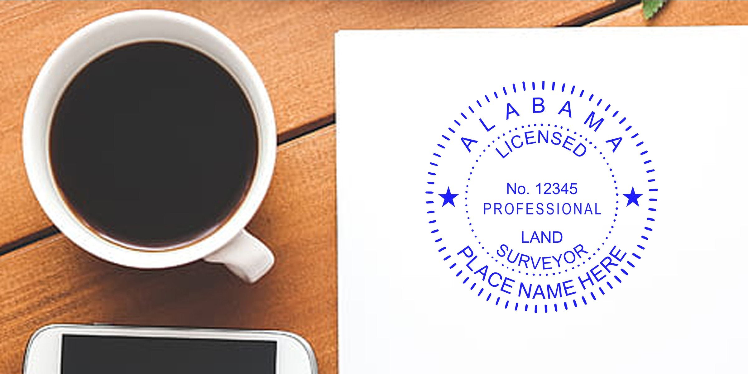 Alabama land surveyor embosser stamp on white paper next to coffee cup, smartphone, and surveyor tools on wooden desk.