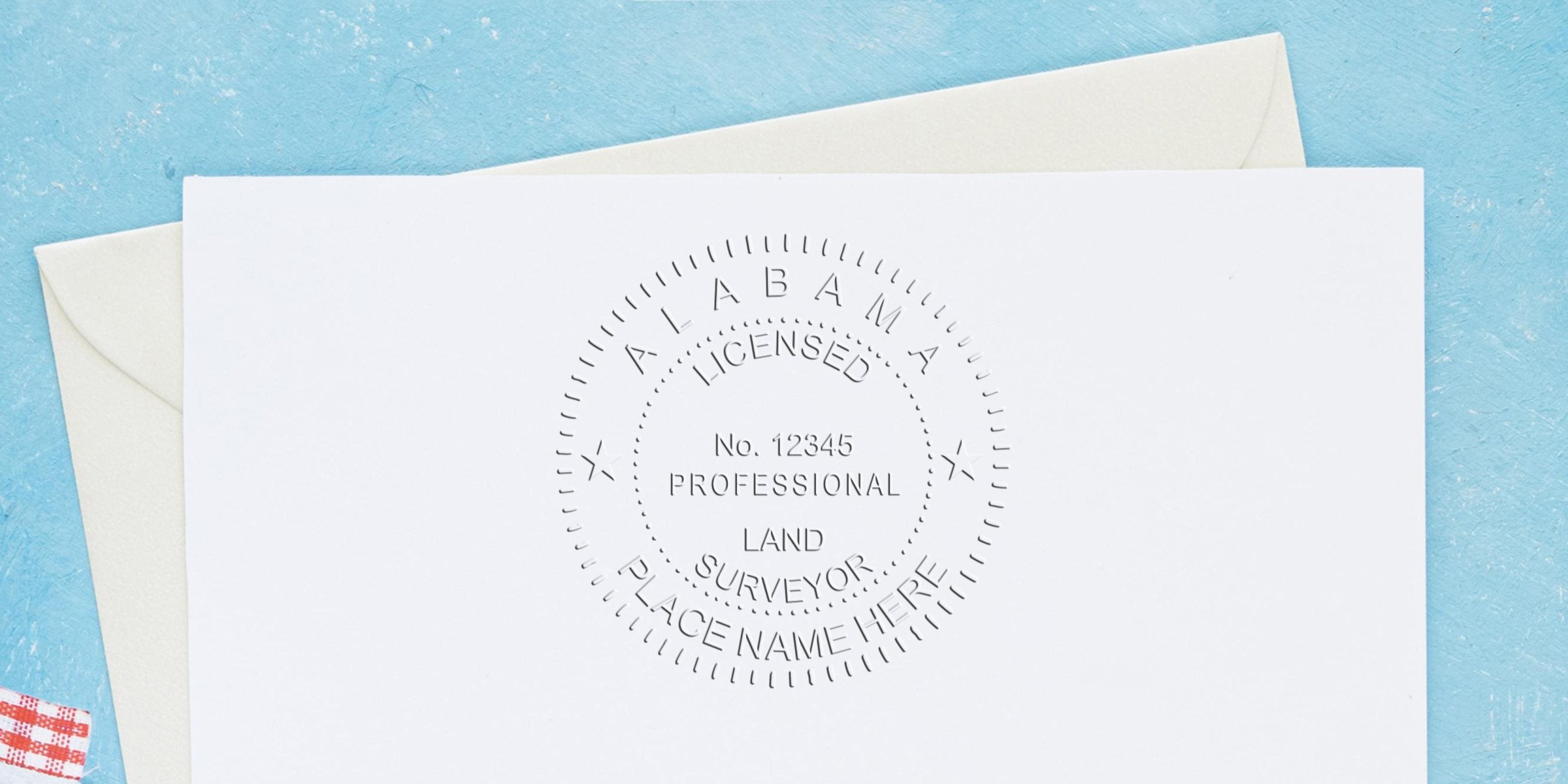 Embossed Alabama Professional Land Surveyor stamp on white paper with envelope, set against a blue background, showcasing Alabama Land Surveyor Certification.