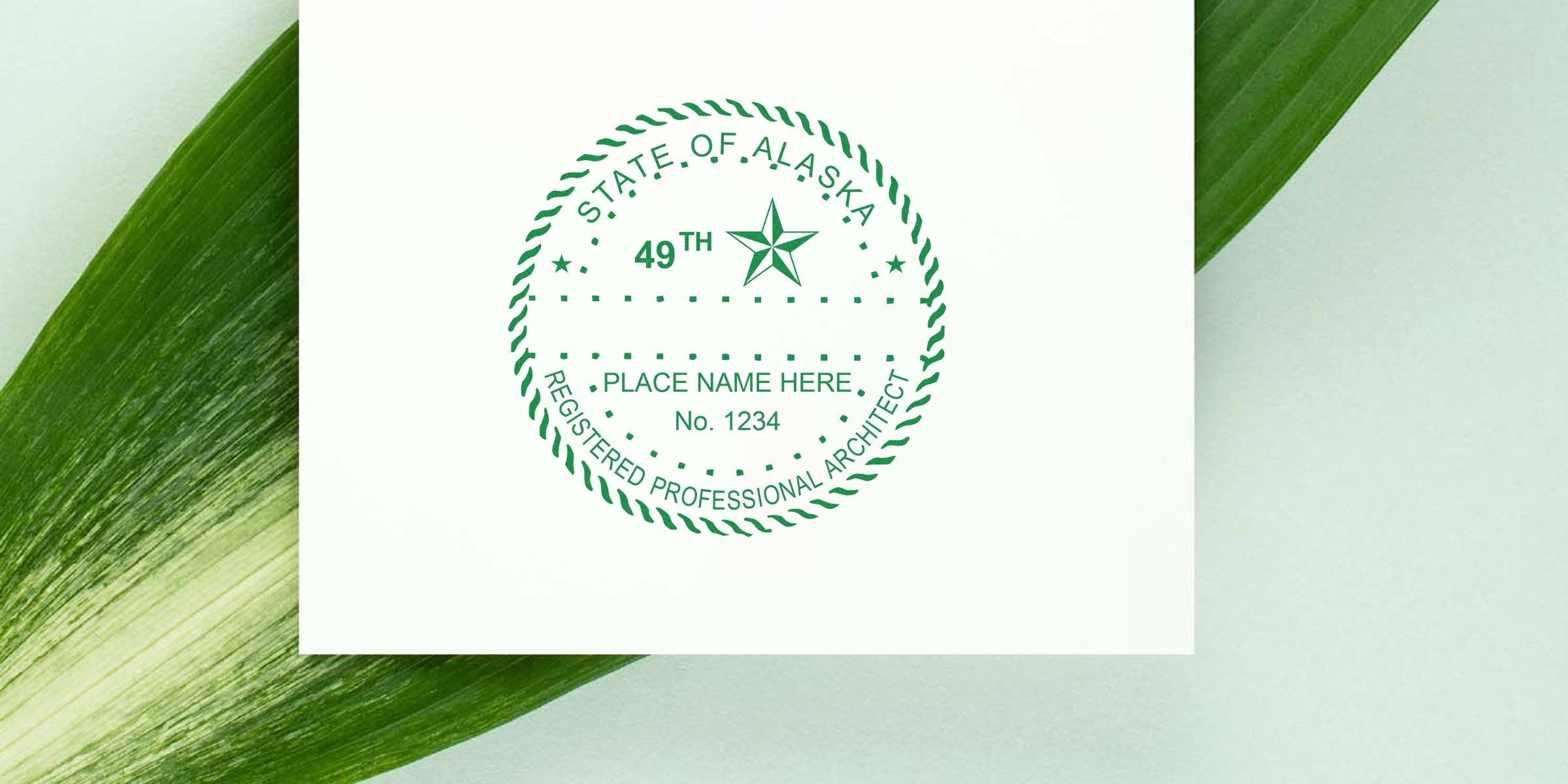 Alaska architect stamp embossed on white paper with green leaves, showing the Alaska registered professional architect seal and embossers.