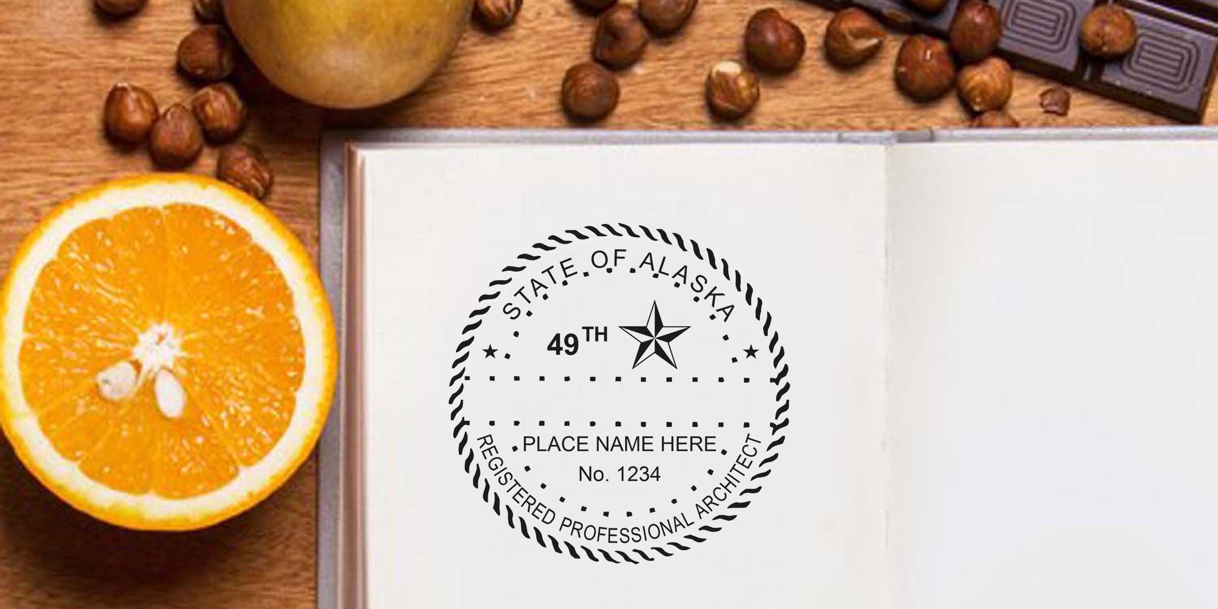 Alaska registered architect seal on open notebook with orange slice, hazelnuts, and chocolate on wooden table, symbolizing Alaska architect stamp and license renewal.