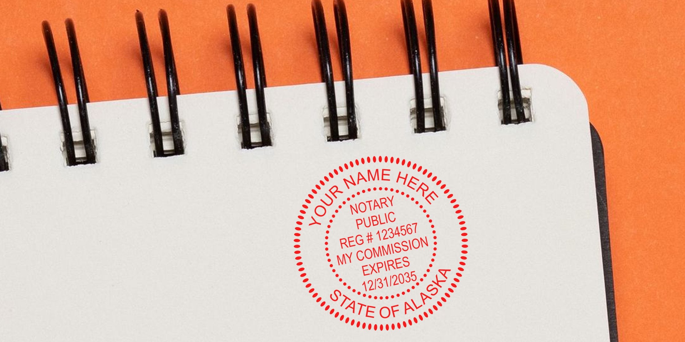 Alaska notary public stamp on spiral notebook with orange background, part of Alaska notary kit and supplies.