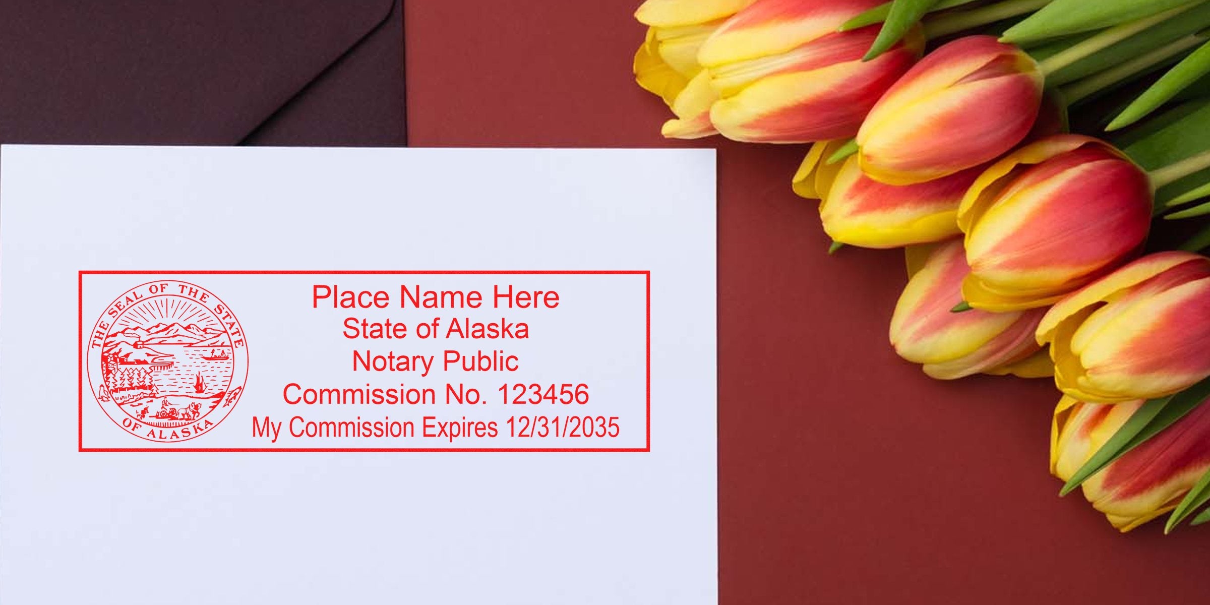 Alaska notary public stamp with commission number on white paper, next to yellow and red tulips on a red background, showcasing Alaska notary supplies and tools.