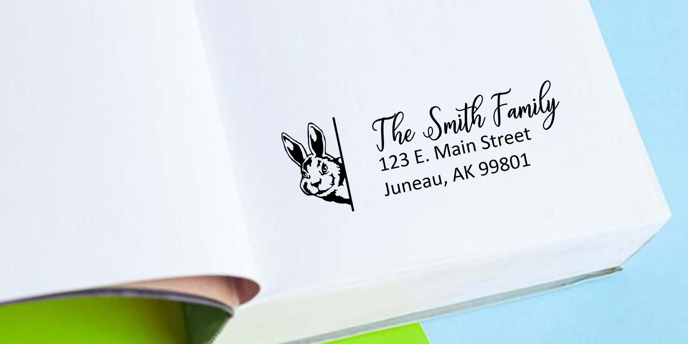 Custom family return address stamp with rabbit logo on white envelope reading The Smith Family, 123 E. Main Street, Juneau, AK 99801