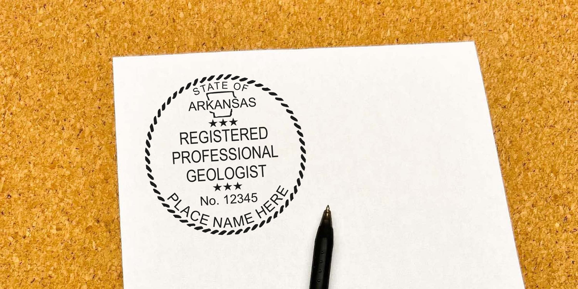 Arkansas Geologist Stamp on white paper with pen, pinned to corkboard, following Stamp Guidelines.