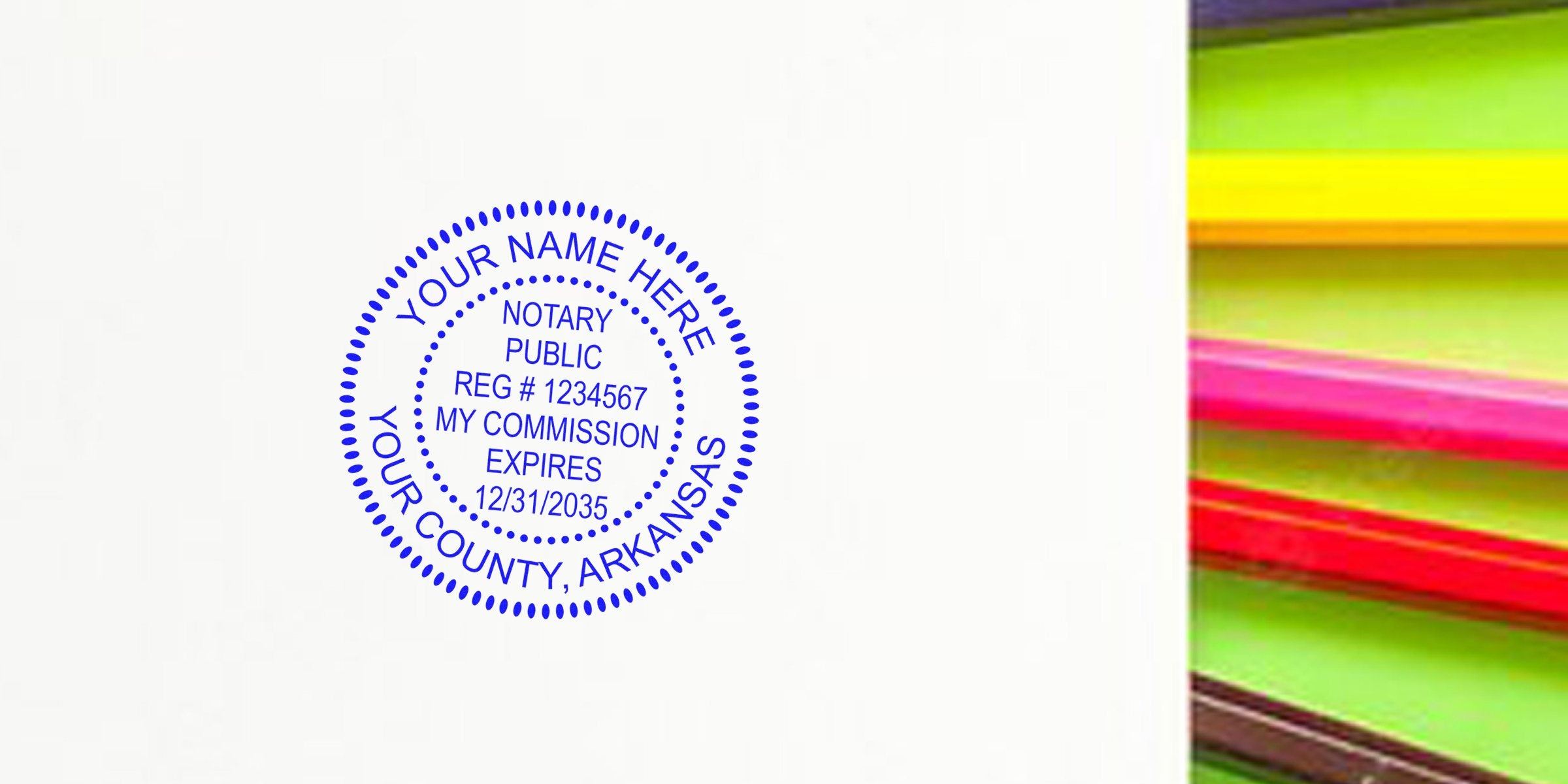 Blue Arkansas notary seal stamp on white paper with colorful pencils, official notary public stamp meeting all guidelines.