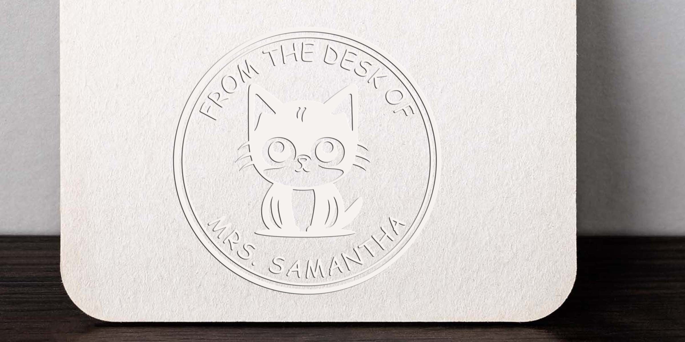 Embossed cat logo on textured white stationery with “From the Desk of Mrs. Samantha” personalized branding seal