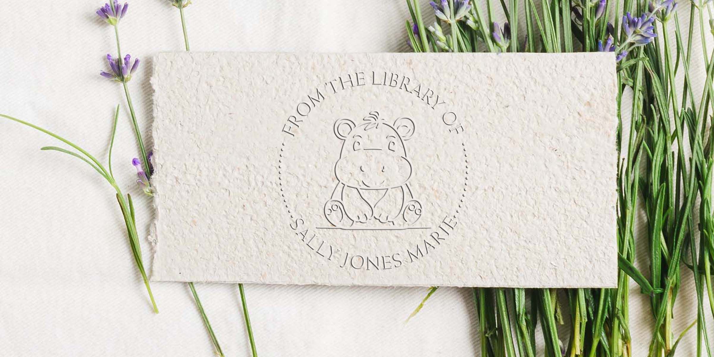 Custom bookplate with hippo logo and “From the Library of” text, surrounded by lavender flowers on a white textured background