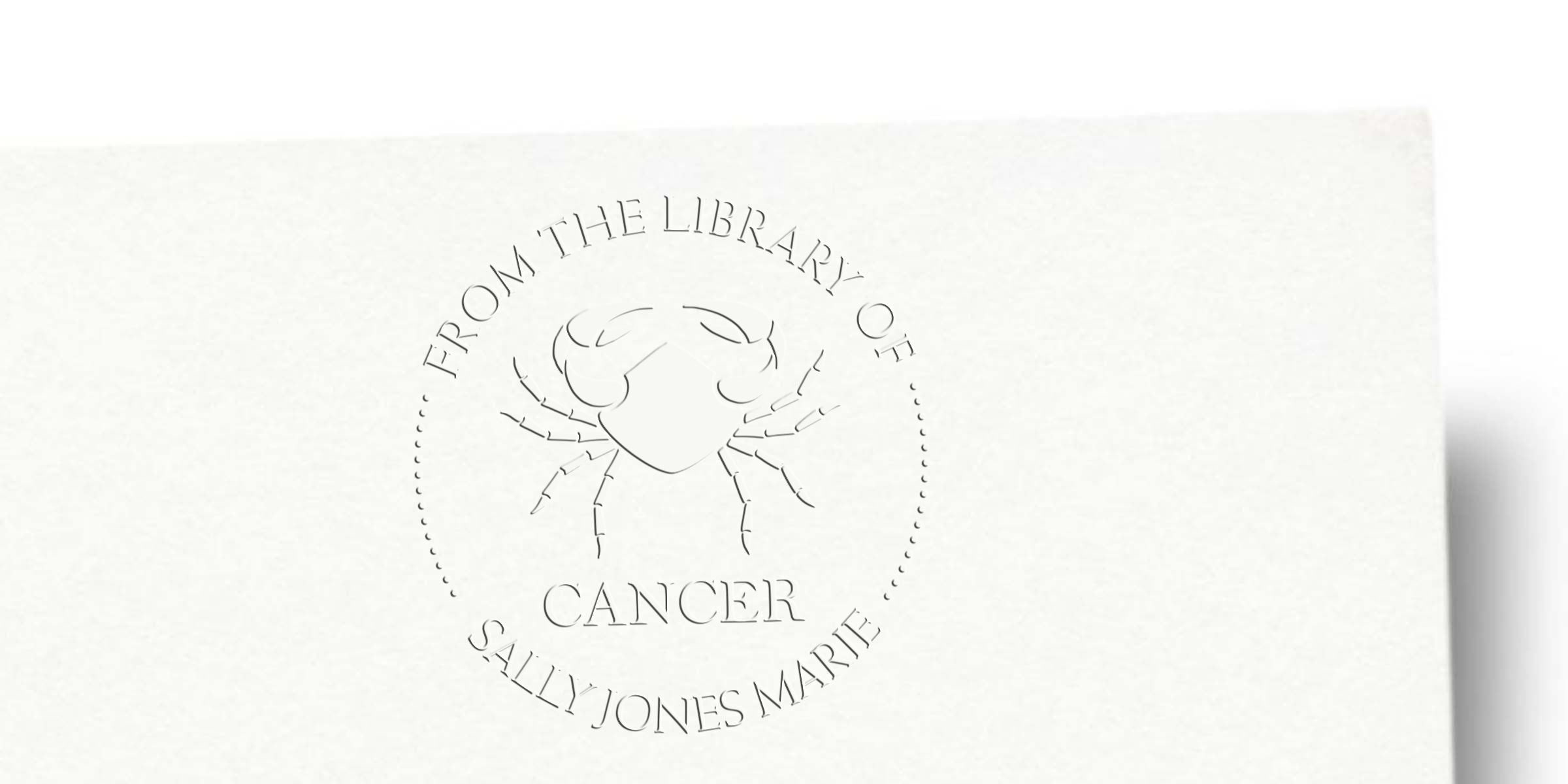Embossed white bookplate with a crab illustration and the text “From the Library of Cancer” and “Sally Jones Marie,” featuring a minimalist Cancer zodiac design