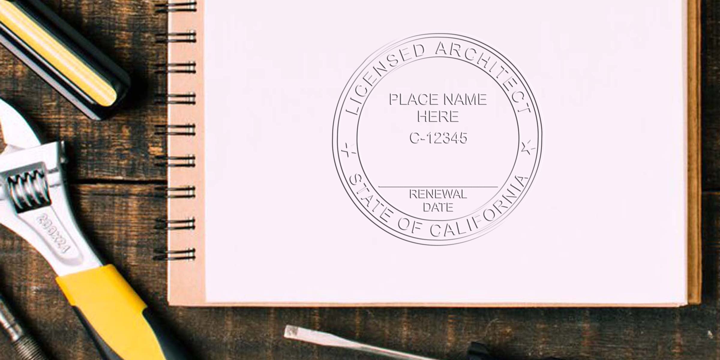 California architect stamp on notebook with wrench and tools on wooden table, showing architect stamp rules for license renewal.