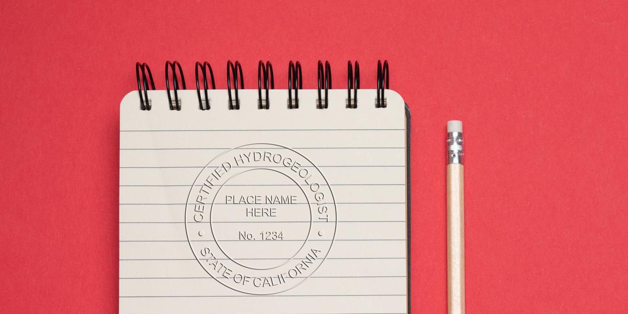 Notebook with California geologist stamp, certified hydrogeologist seal, and pencil on red background, emphasizing geologist stamp rules.