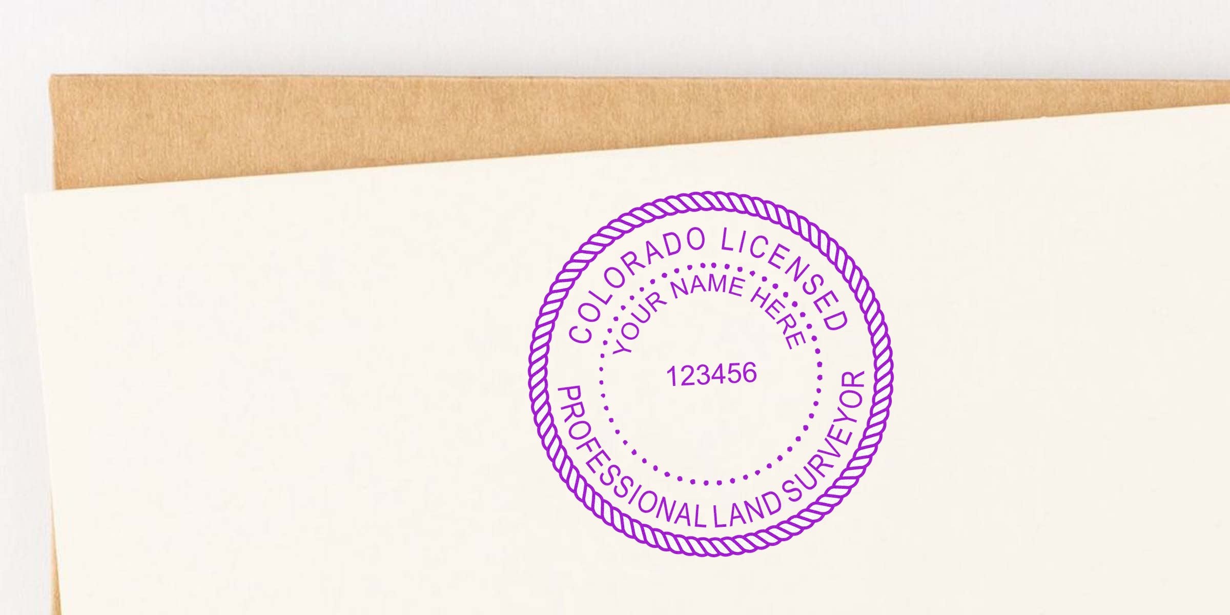 Colorado land surveyor stamp on paper with envelope, meeting all land surveyor stamp requirements.