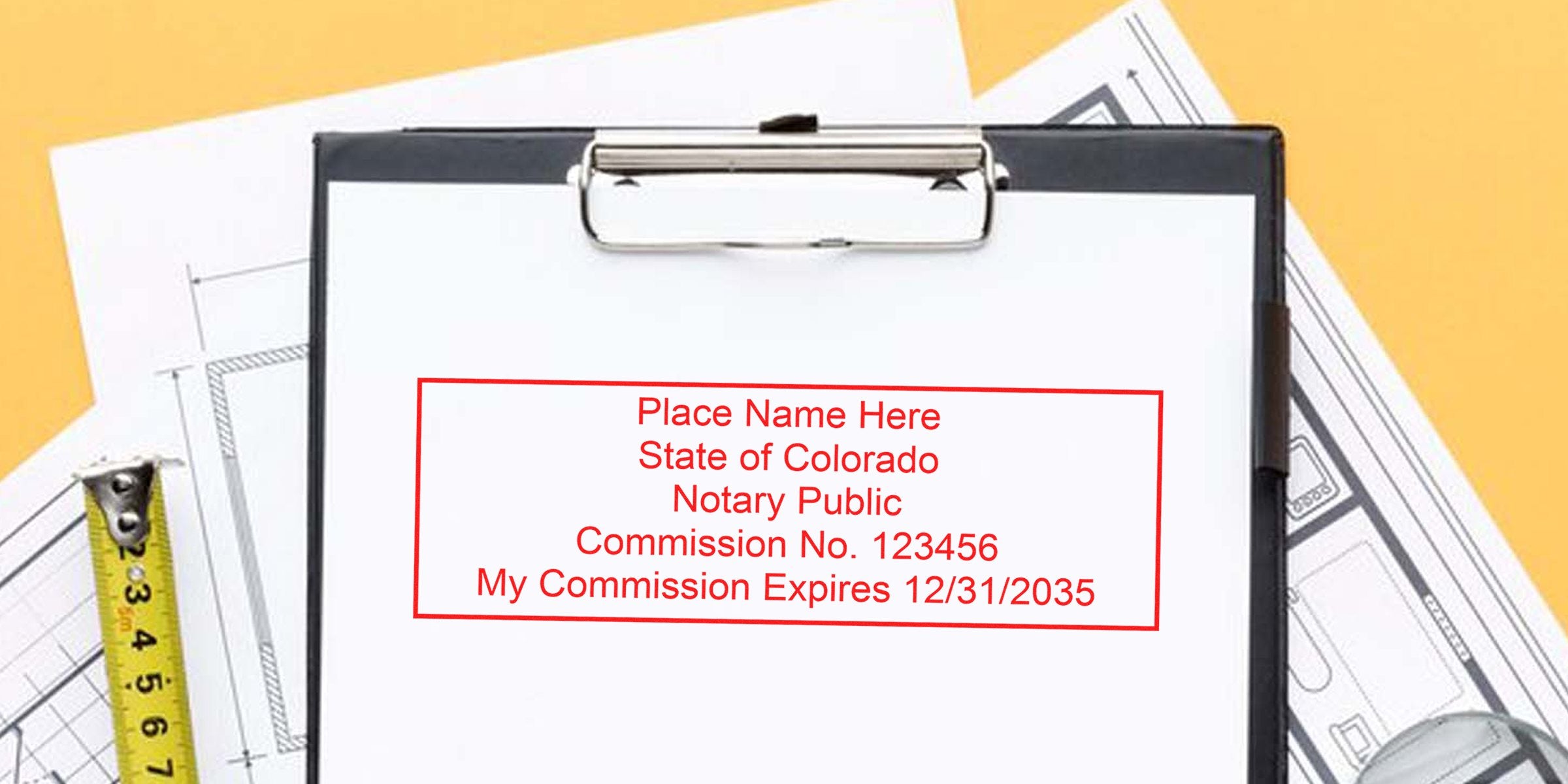 Colorado notary public commission certificate on clipboard with architectural plans, measuring tape, notary stamp, and Colorado Notary Supplies.