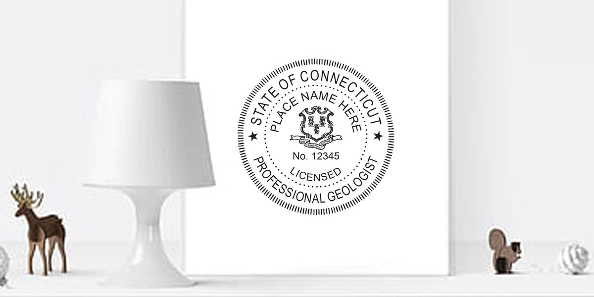 Connecticut geologist seal on white wall, showing professional license with seal details, alongside a modern lamp and decorative animal figurines.