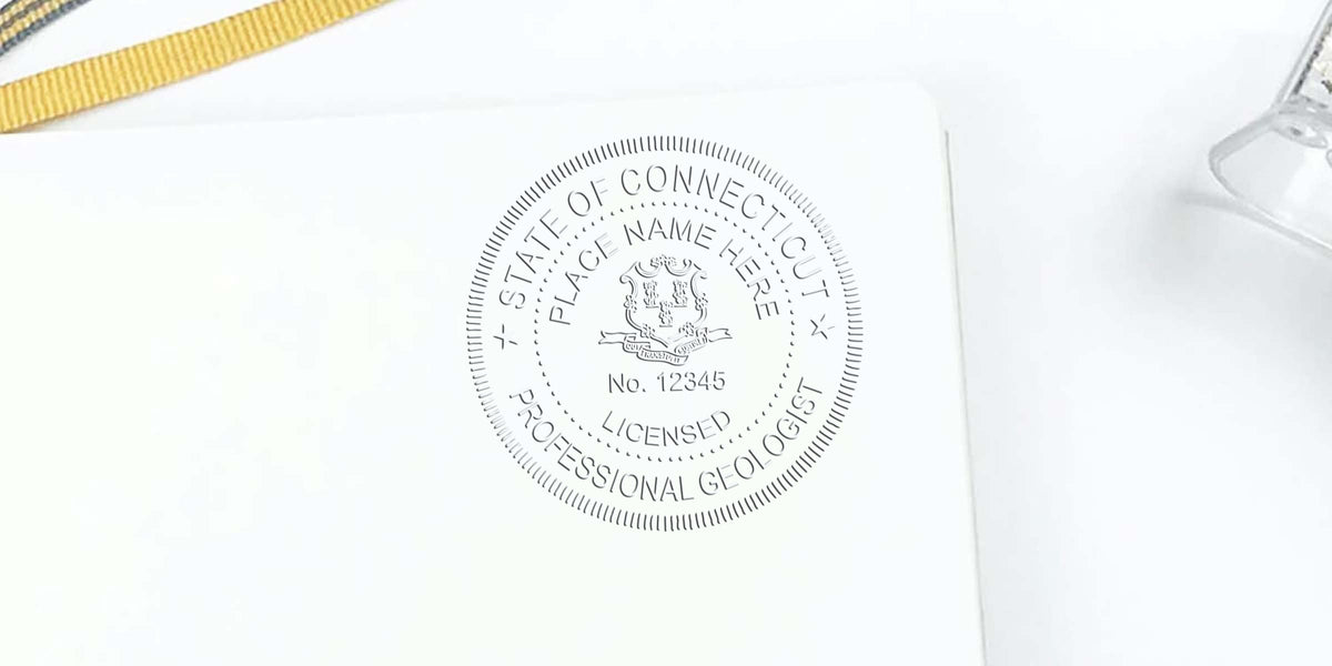 Connecticut geologist embossed seal on white paper with gold ribbon and clear holder, meeting geologist stamp guidelines.