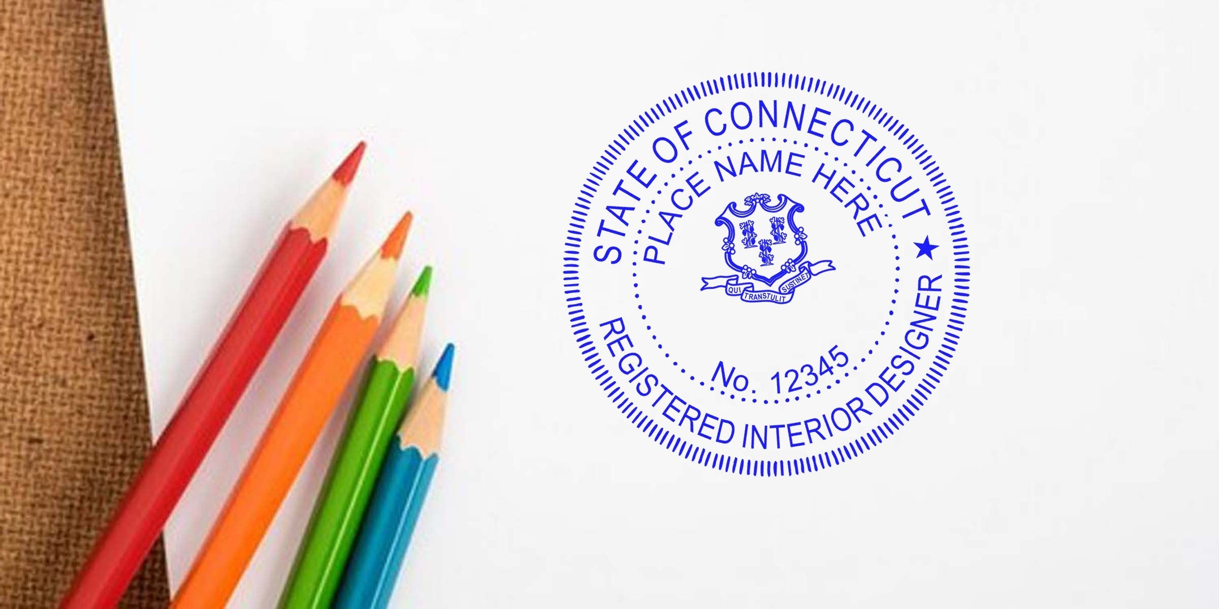 Connecticut interior designer’s stamp on white paper with colorful pencils, emphasizing the significance of stamp size.
