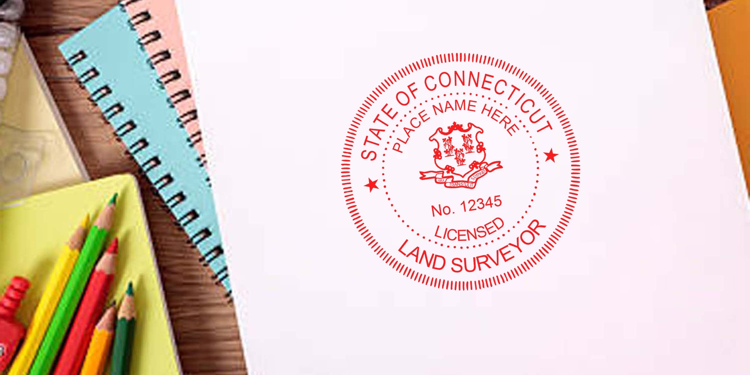 Connecticut land surveyor stamp on white paper, surrounded by colorful pencils and notebooks on a wooden desk, illustrating stamp requirements.