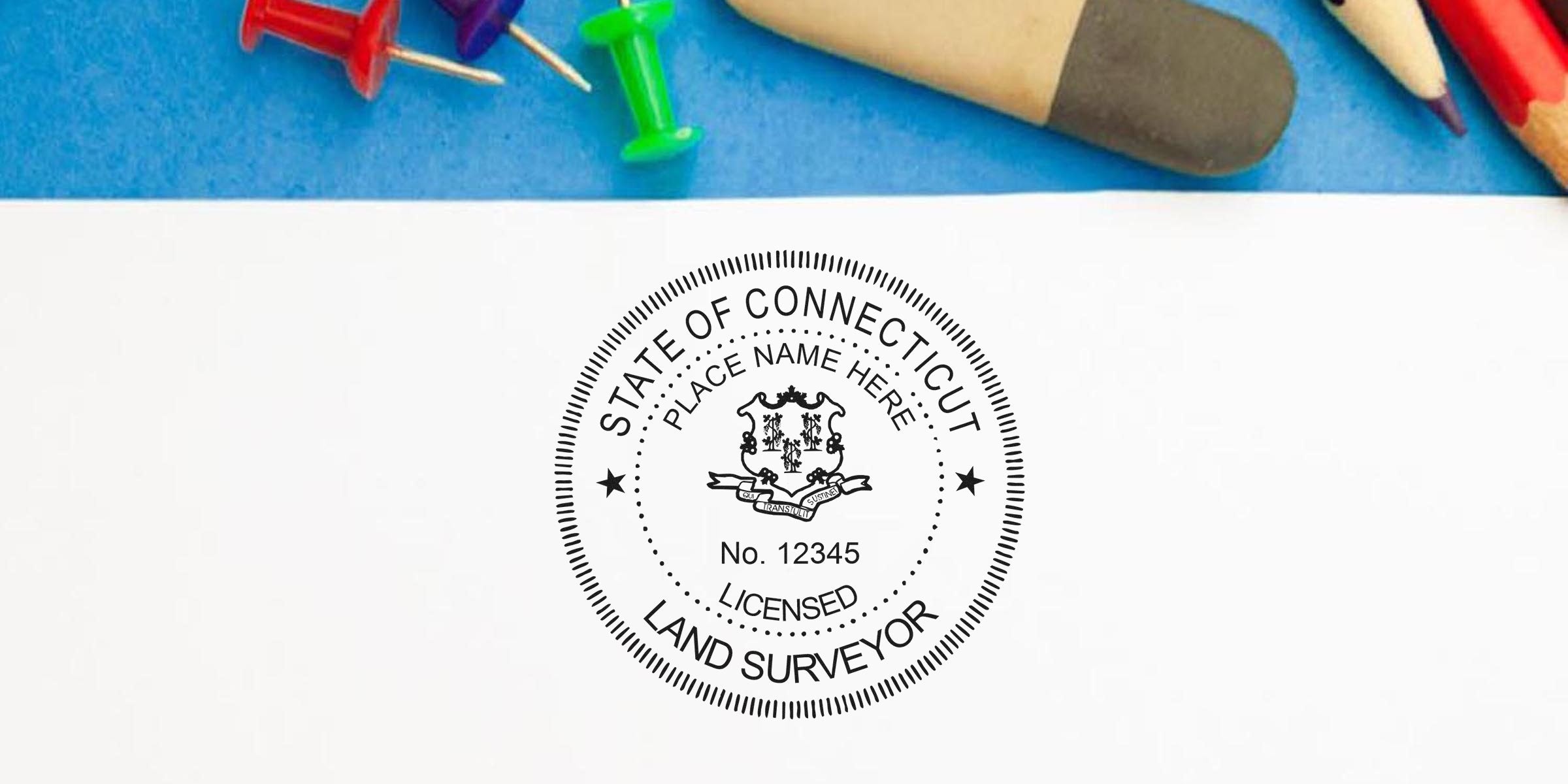Connecticut land surveyor stamp with official state emblem and certification number on white paper, surrounded by colorful office supplies—perfect for buying a land surveyor stamp online.