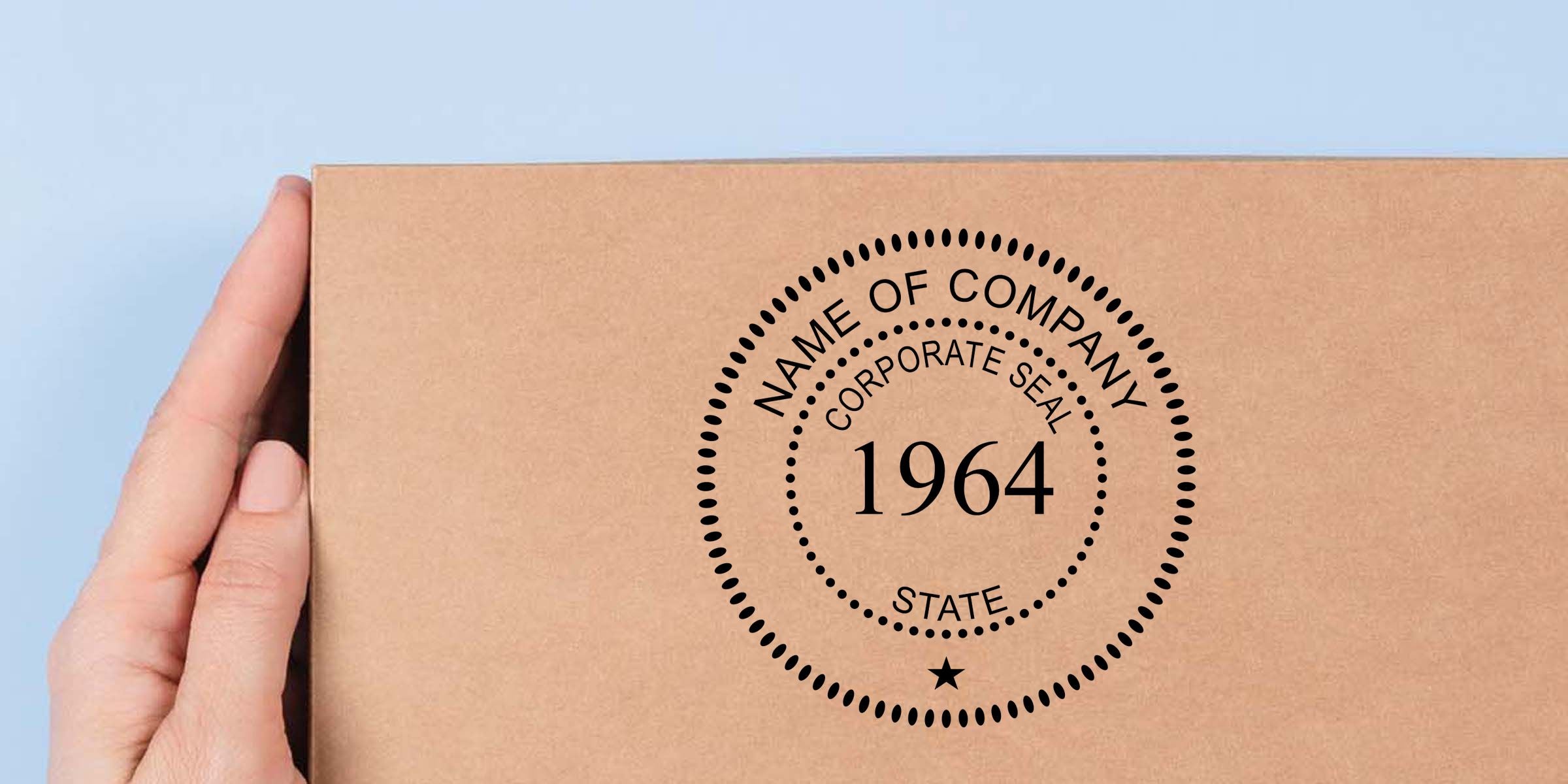Hand holding a kraft cardboard box with a custom corporate seal logo design reading Name of Company, Corporate Seal, State, and 1964 against a light blue background