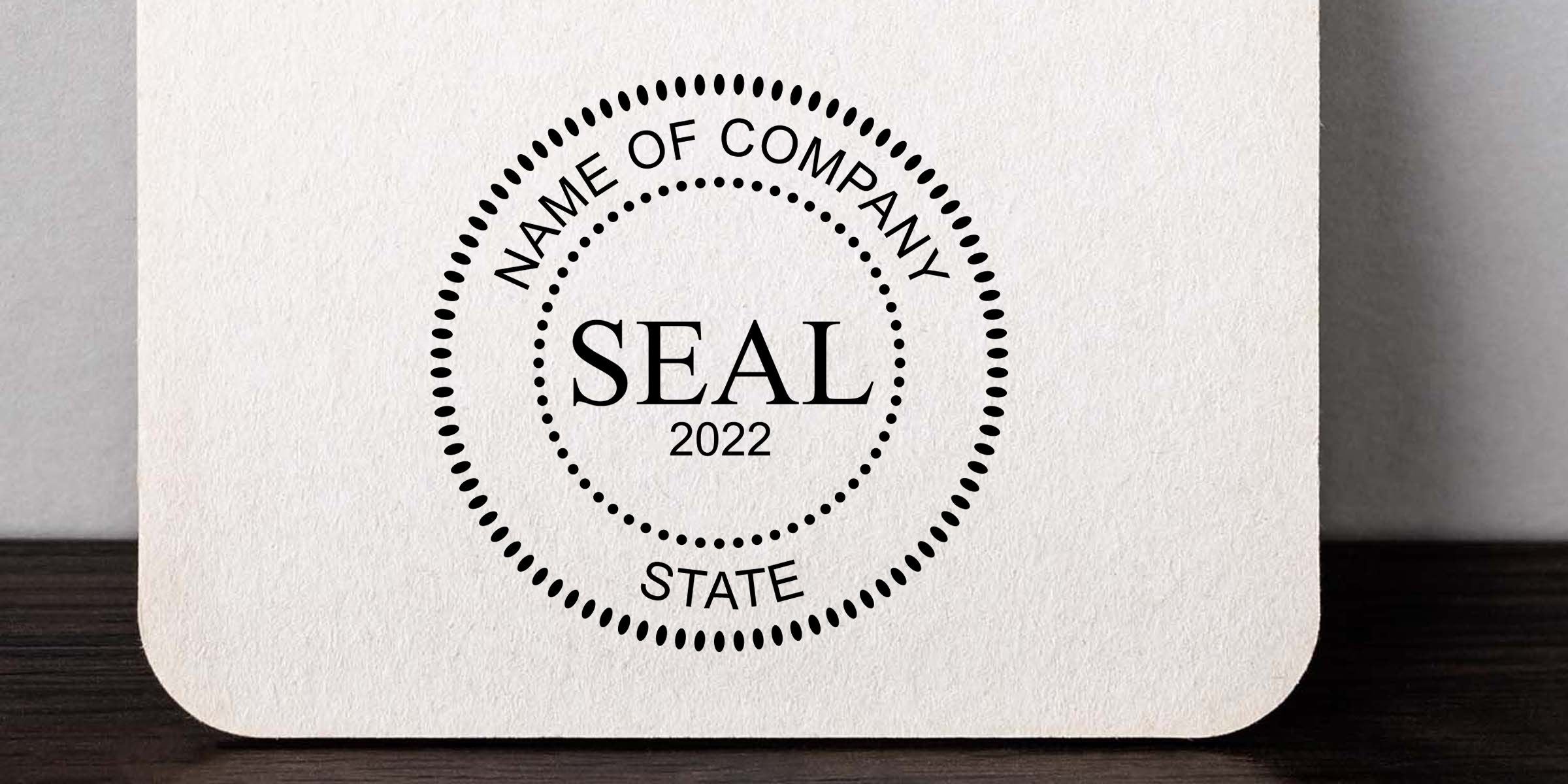 Custom company seal stamp design with circular dotted border, “Name of Company,” “SEAL 2022,” and “STATE” on textured white paper background