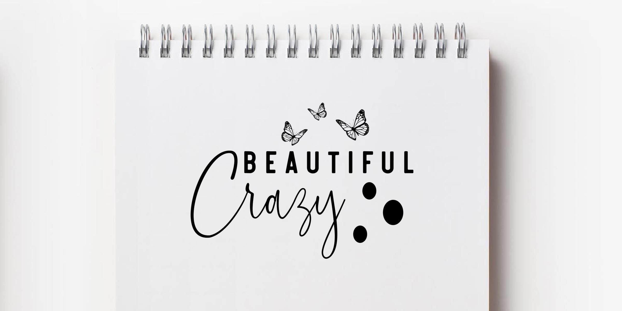 Spiral notebook with “Beautiful Crazy” lettering, butterfly accents, and minimalist black design on a white background
