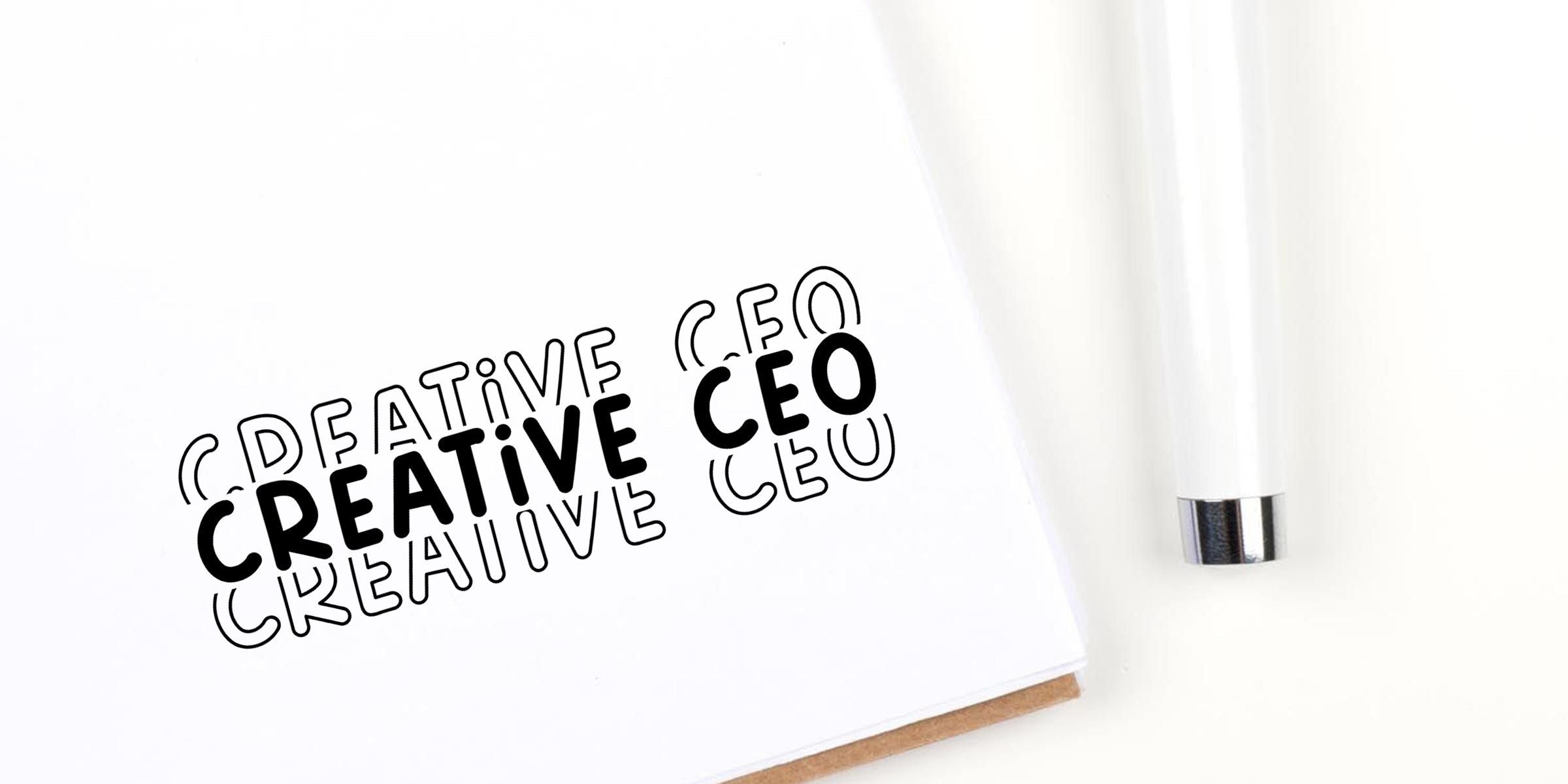 Creative CEO notebook with bold typography and a white pen on a clean minimal desk background