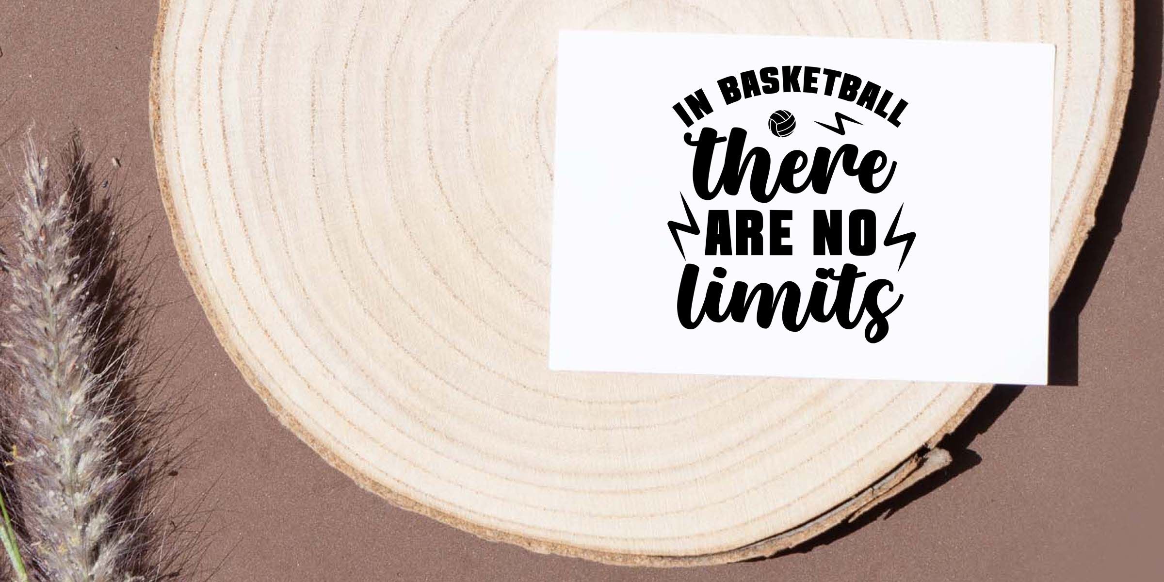 Basketball motivational quote decal reading “In basketball there are no limits” on a wood slice background with natural decor styling