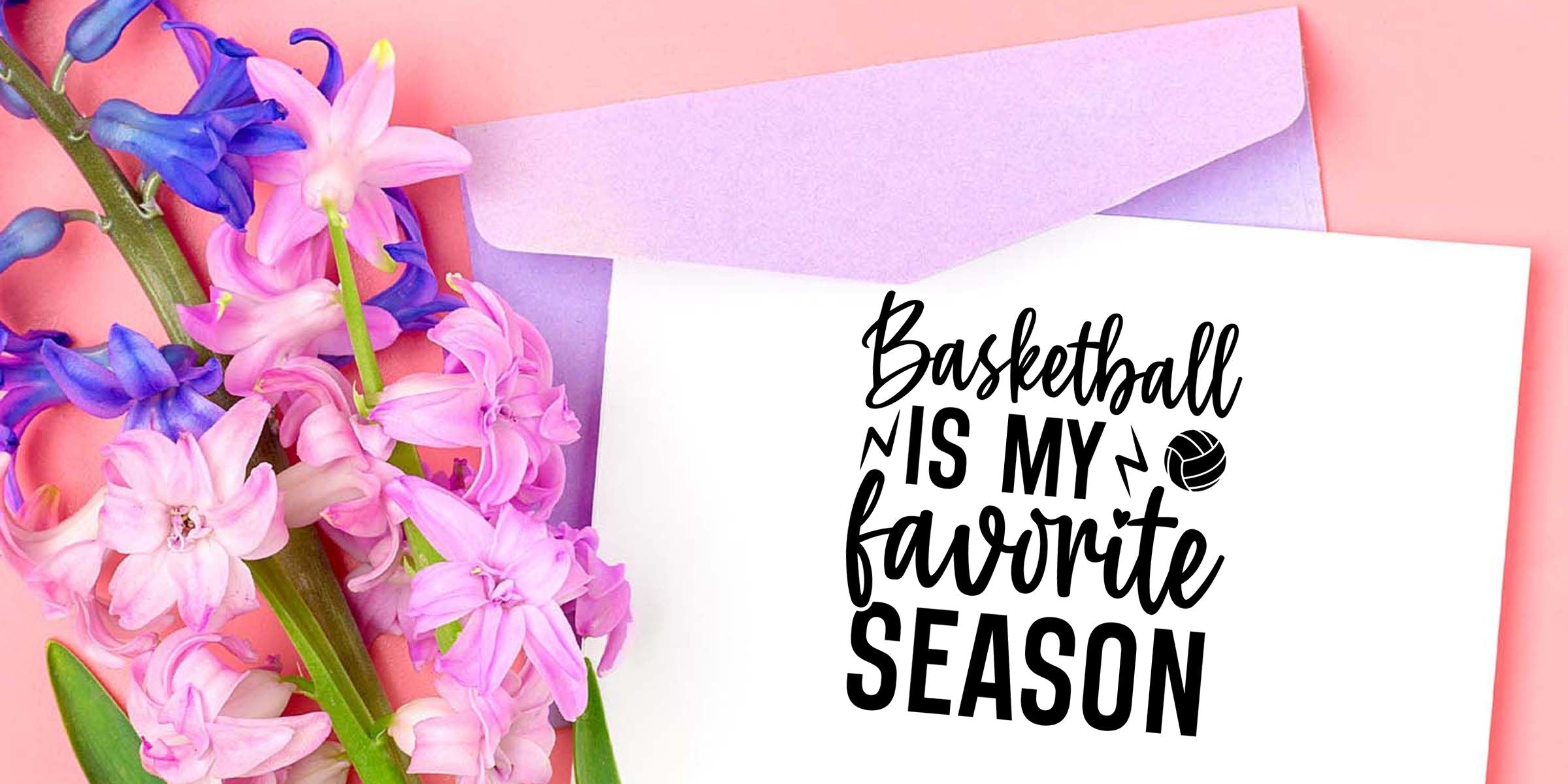 Pink and purple hyacinth flowers beside a white card reading “Basketball is my favorite season” on a pastel pink background