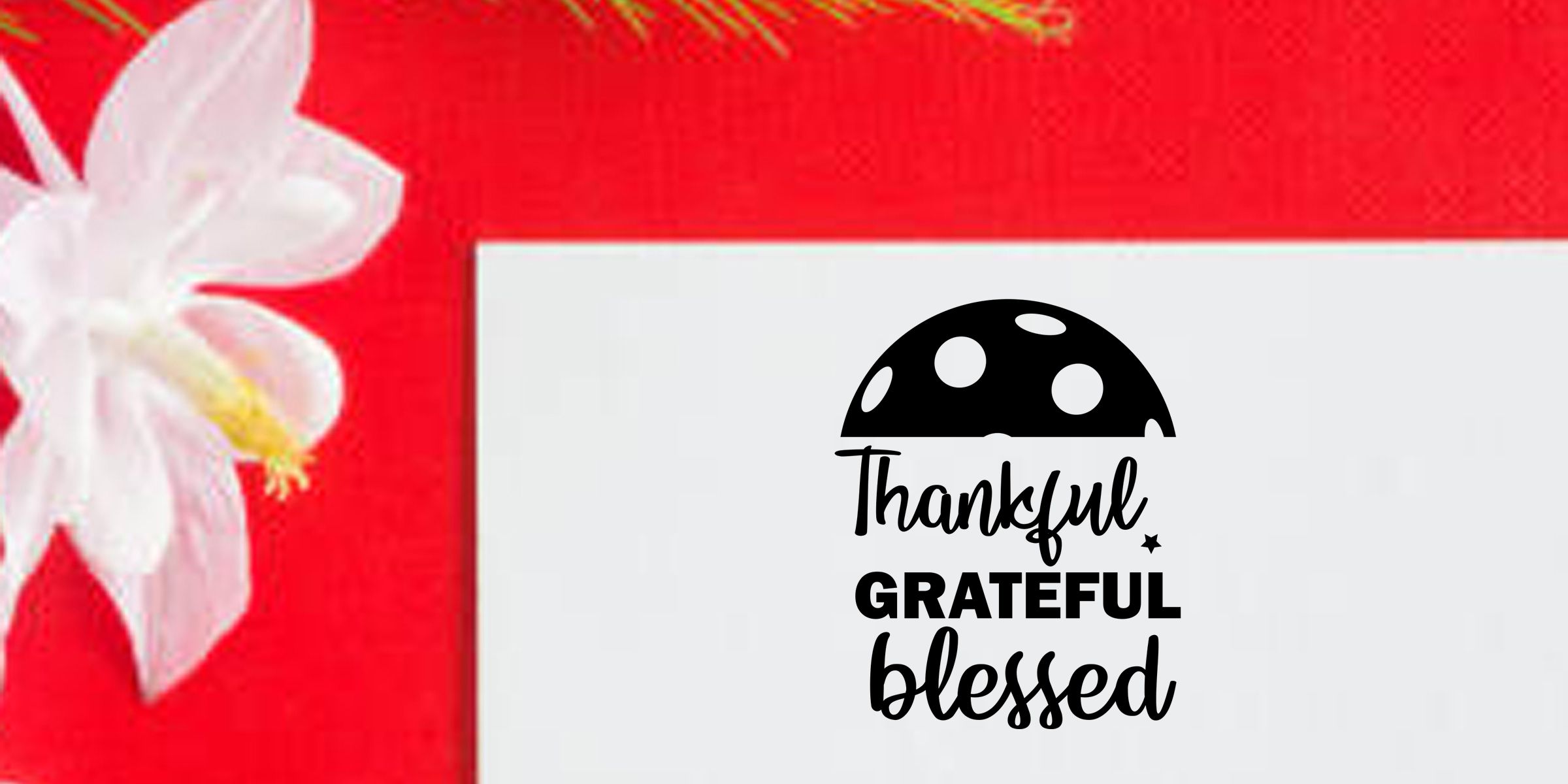 Thankful grateful blessed inspirational typography with black polka dot mushroom graphic on a white card against a vibrant red floral background