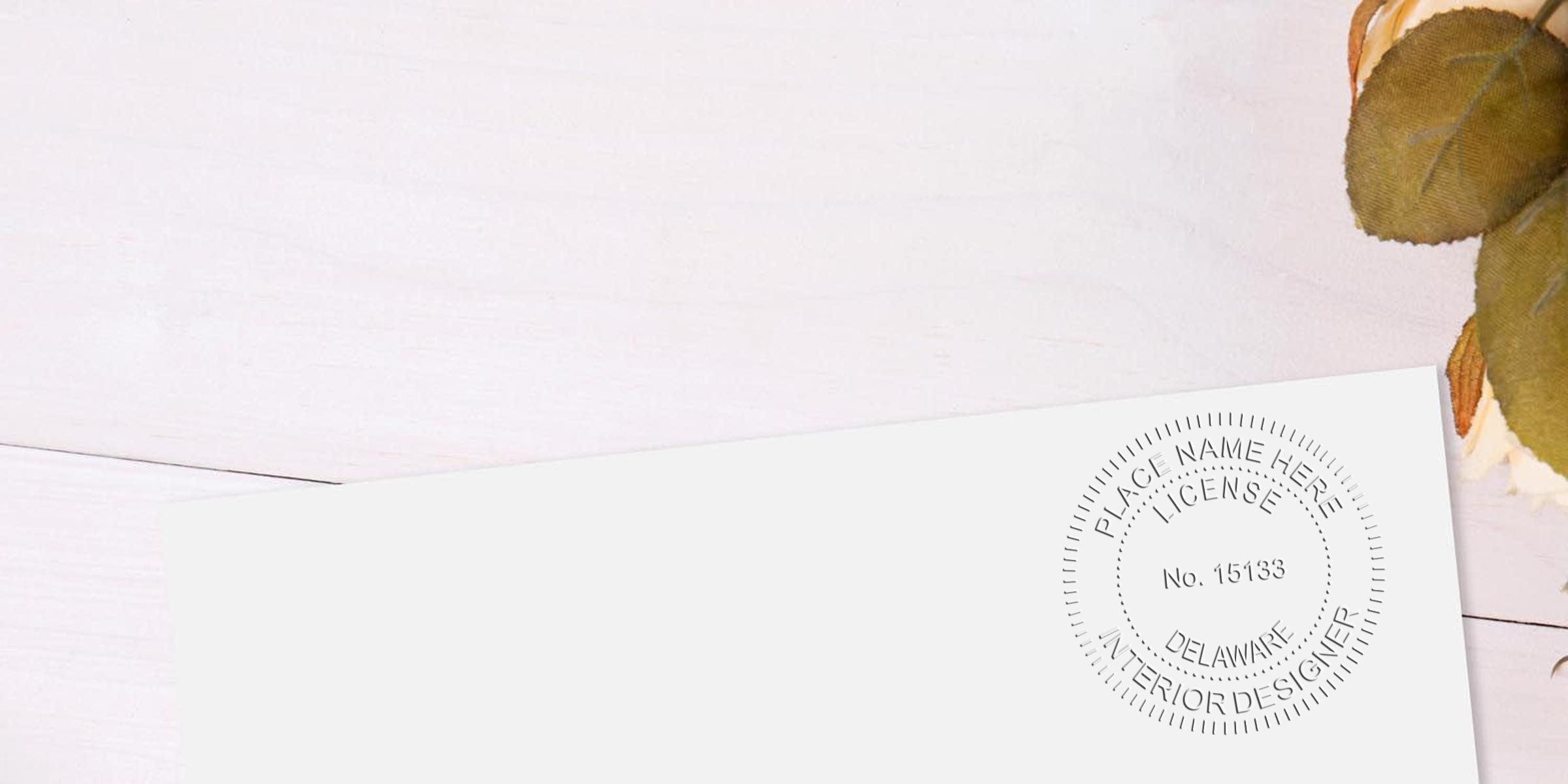 Delaware Interior Design Stamp on white paper with autumn leaves on a wooden background, highlighting Interior Design Certification in Delaware.