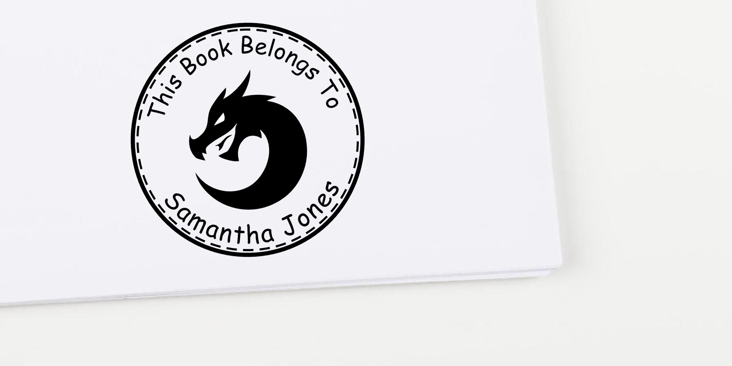 Custom bookplate label with dragon logo and the text “This Book Belongs To Samantha Jones” on a white background