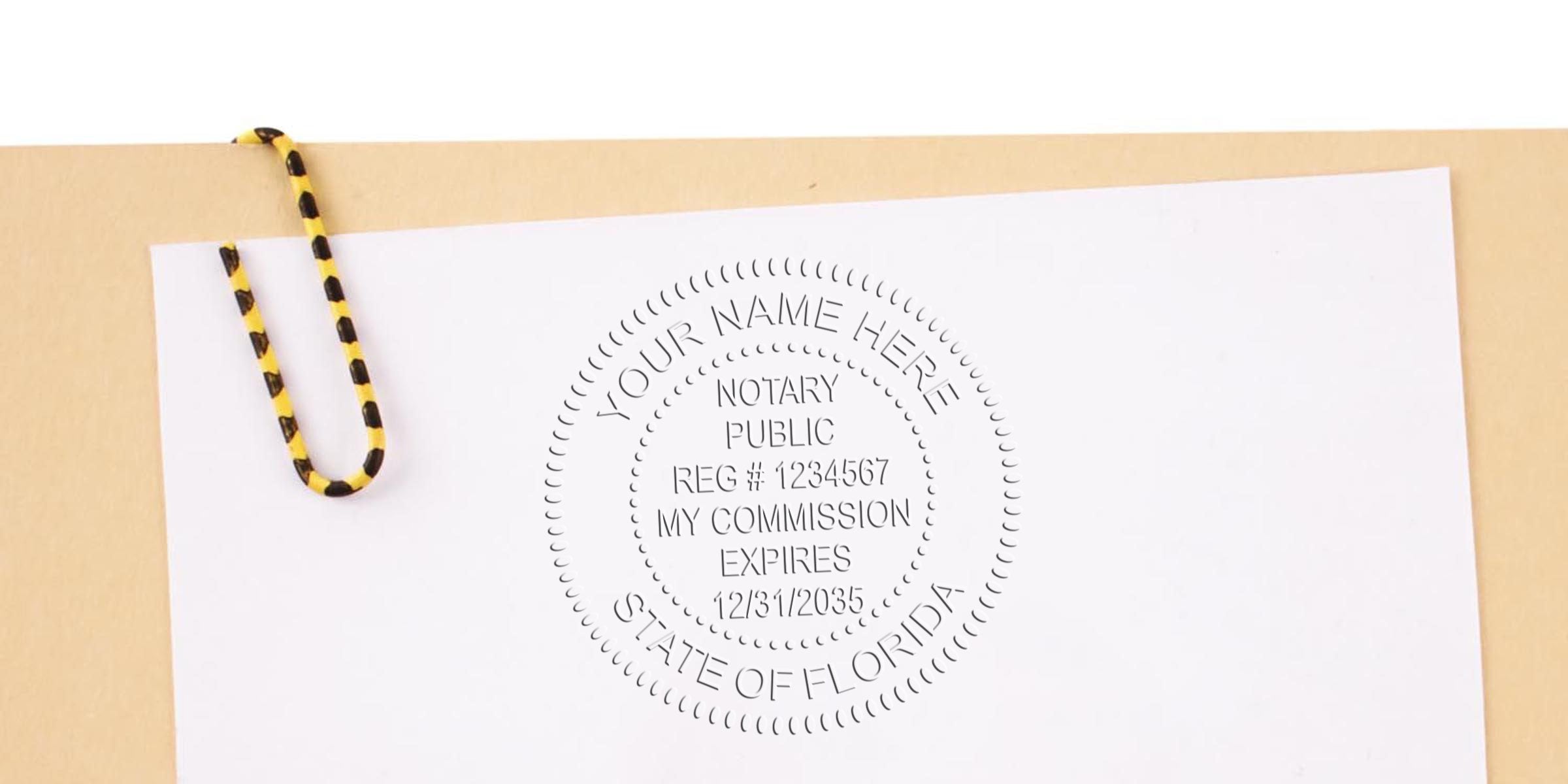 Florida notary public stamp on white paper with yellow and black paperclip, related to Florida notary stamp renewal and compliance.