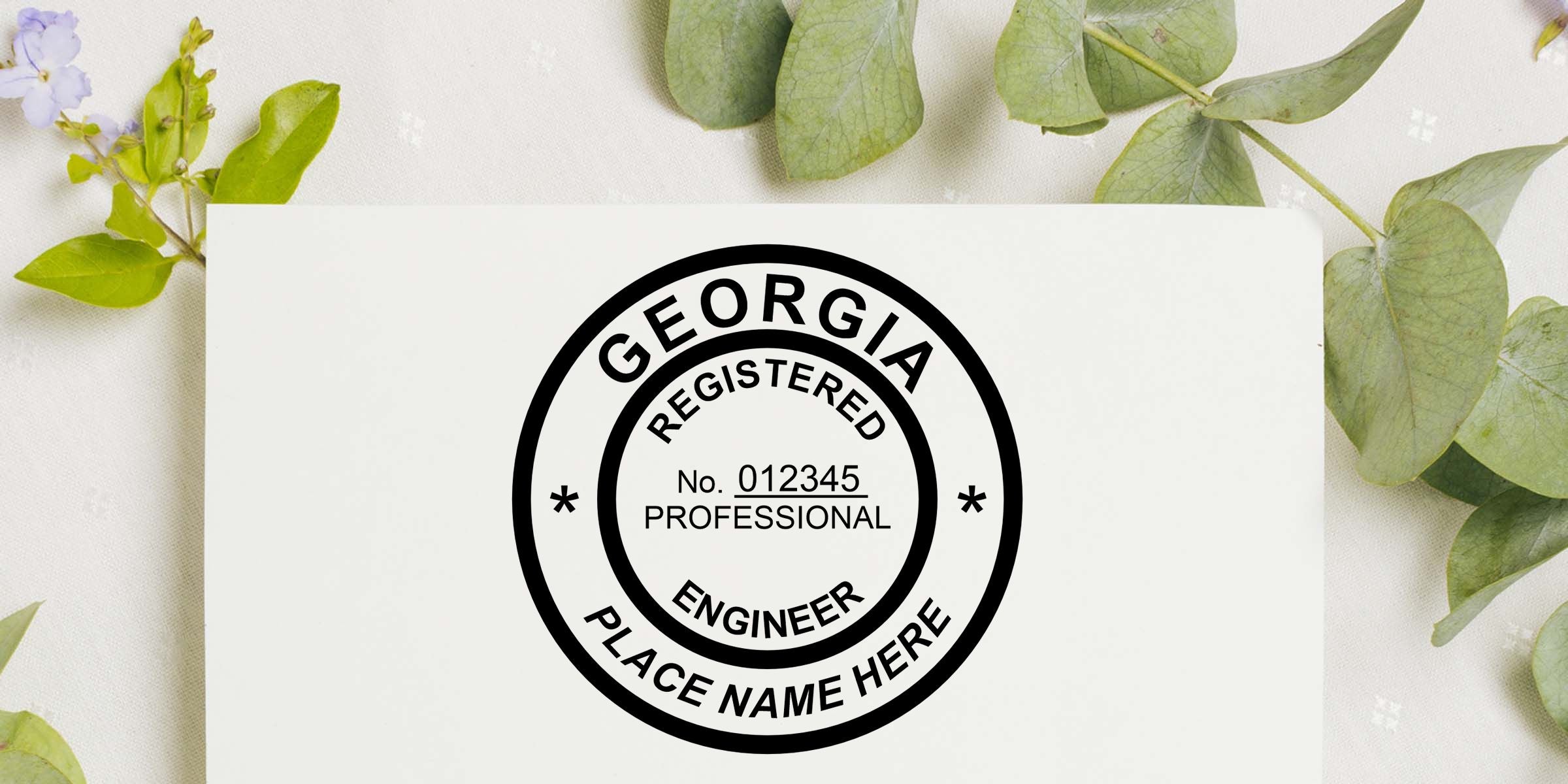 Georgia registered professional engineer stamp with license number 012345 and placeholder name on a white card surrounded by green leaves and floral accents