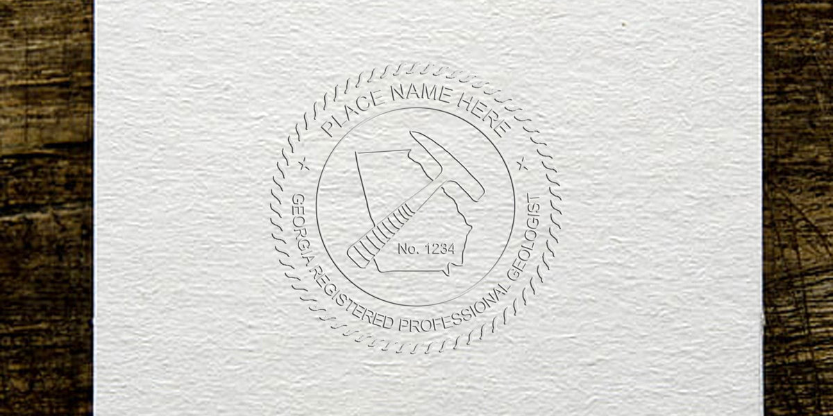 Embossed Georgia professional geologist seal with geological hammer and state outline on textured paper, for Georgia Geologist Stamp and License Renewal.