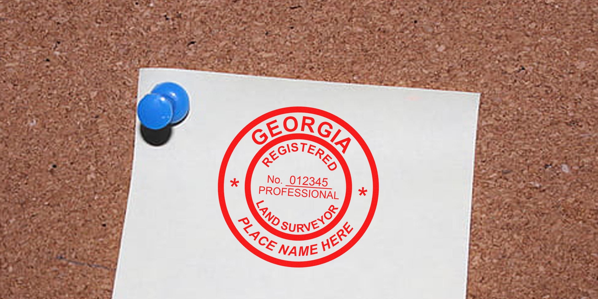 Georgia land surveyor stamp, custom registered professional land surveyor stamp on white paper pinned to corkboard.