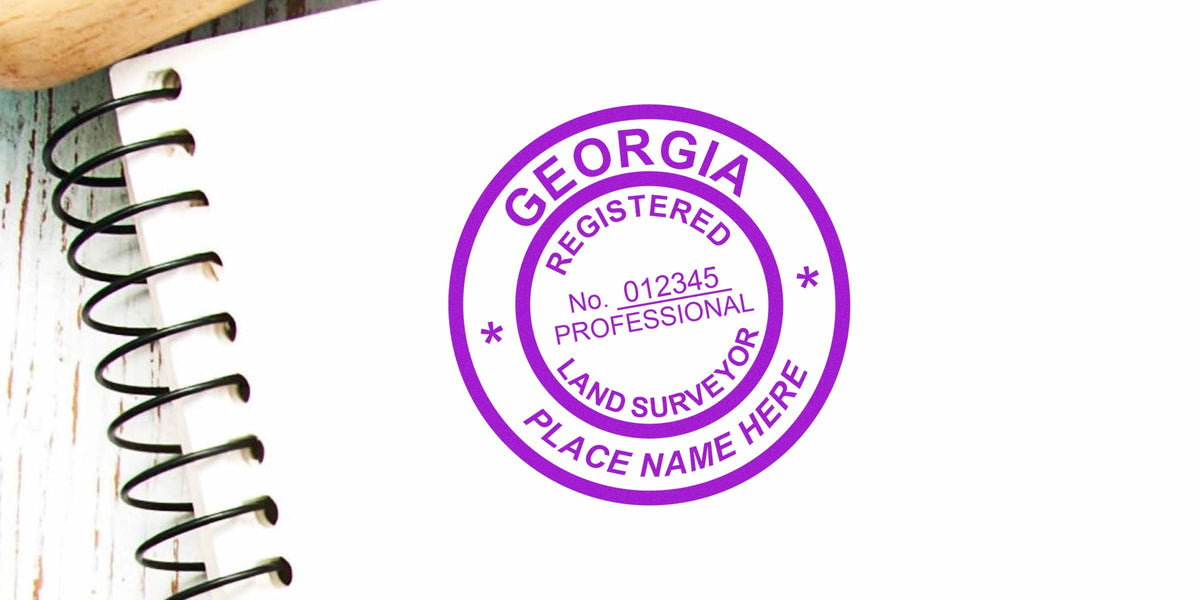 Georgia land surveyor stamp on spiral notebook, highlighting land surveyor costs and stamp prices in Georgia.