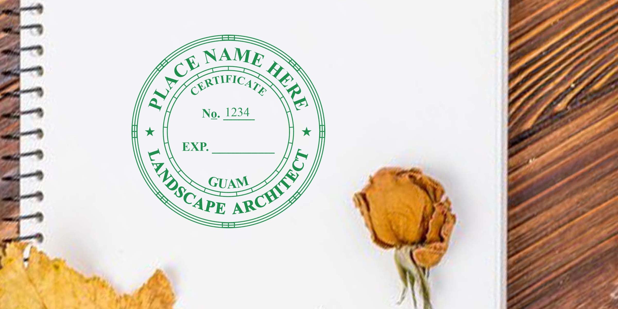 Green Landscape Architect Stamp Guam certification on white notebook with dried flowers on wooden table, showcasing Official Landscape Architect Benefits.