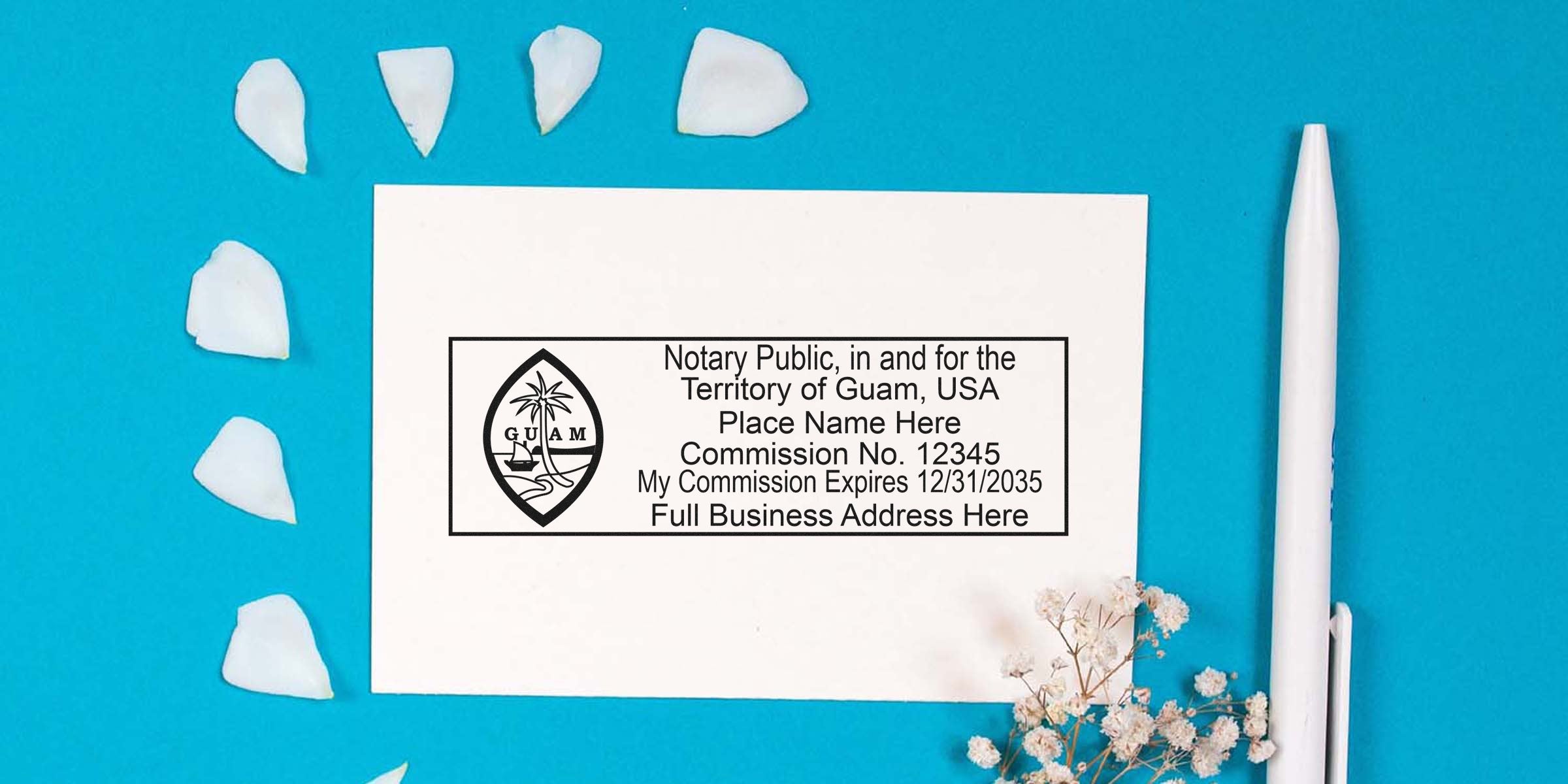 Guam notary seal stamp with commission details on white paper, alongside a white pen and flower petals on a blue background, highlighting essential Guam notary supplies.