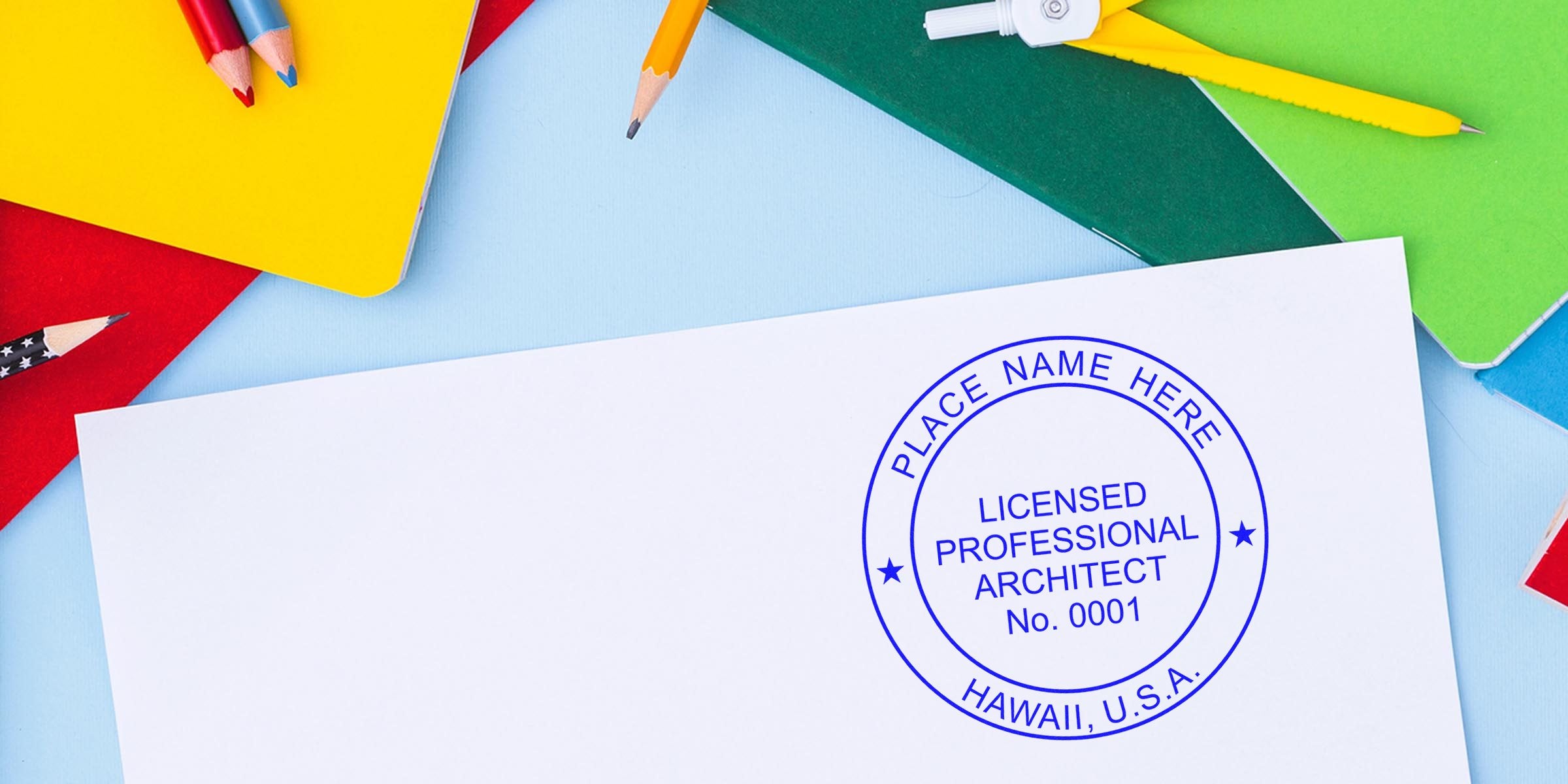 Licensed architect stamp on white paper with colorful notebooks and pencils, showing Hawaii architect stamp requirements and process.