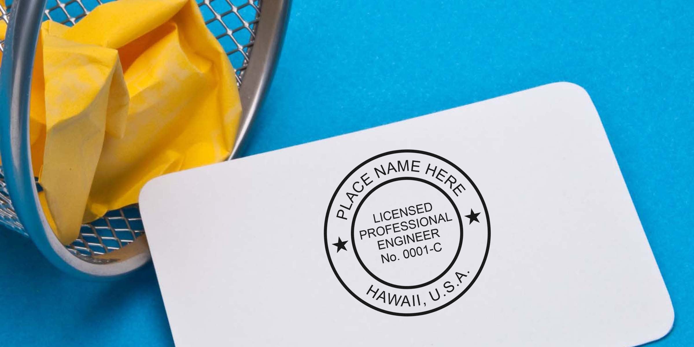 Licensed Professional Engineer stamp on white card with blue background and yellow paper in trash bin, showing Hawaii PE stamp rules and Professional Engineer stamp Hawaii.