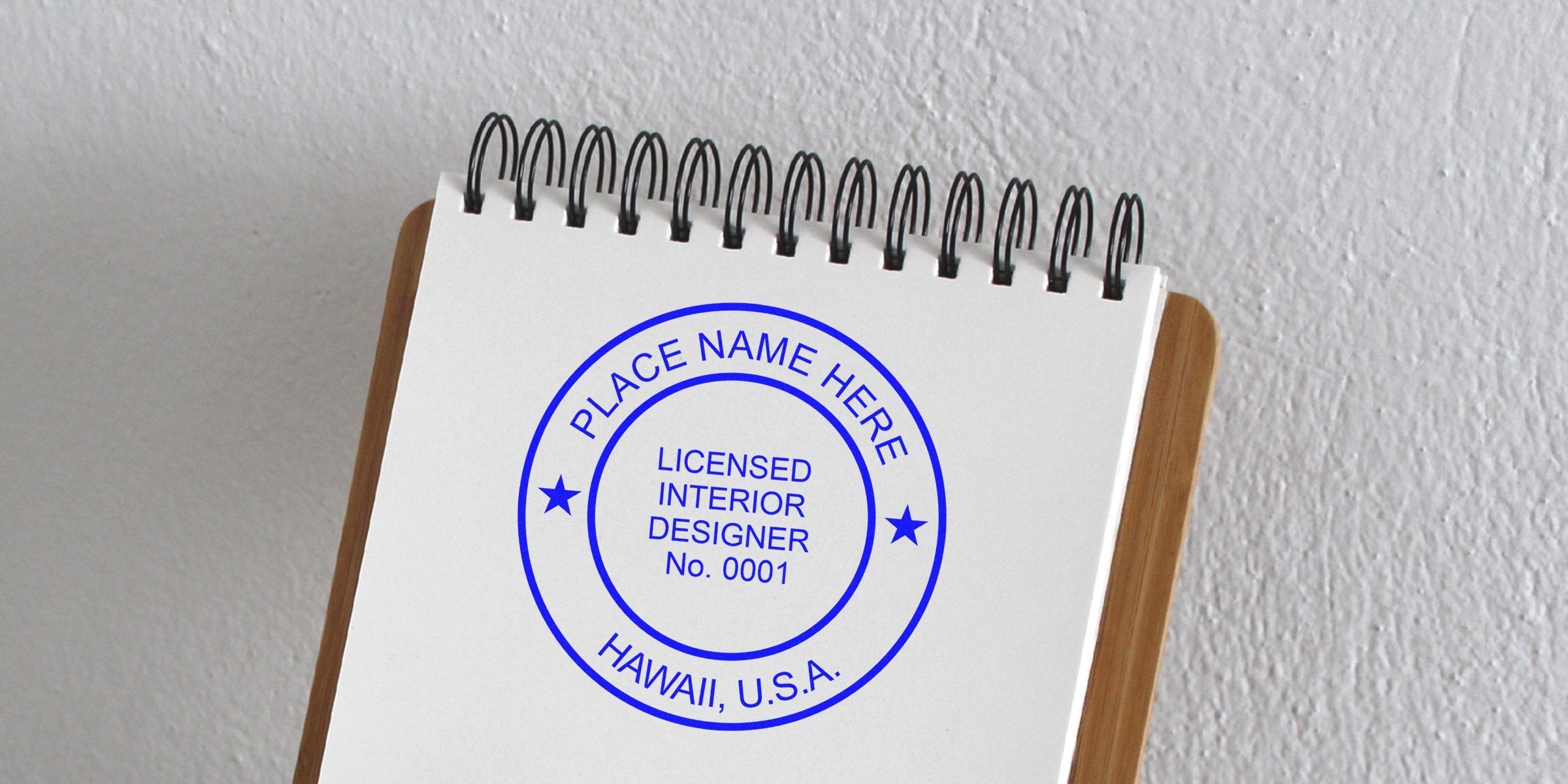 Licensed interior designer stamp on spiral notebook for Hawaii interior design certification and custom home projects.