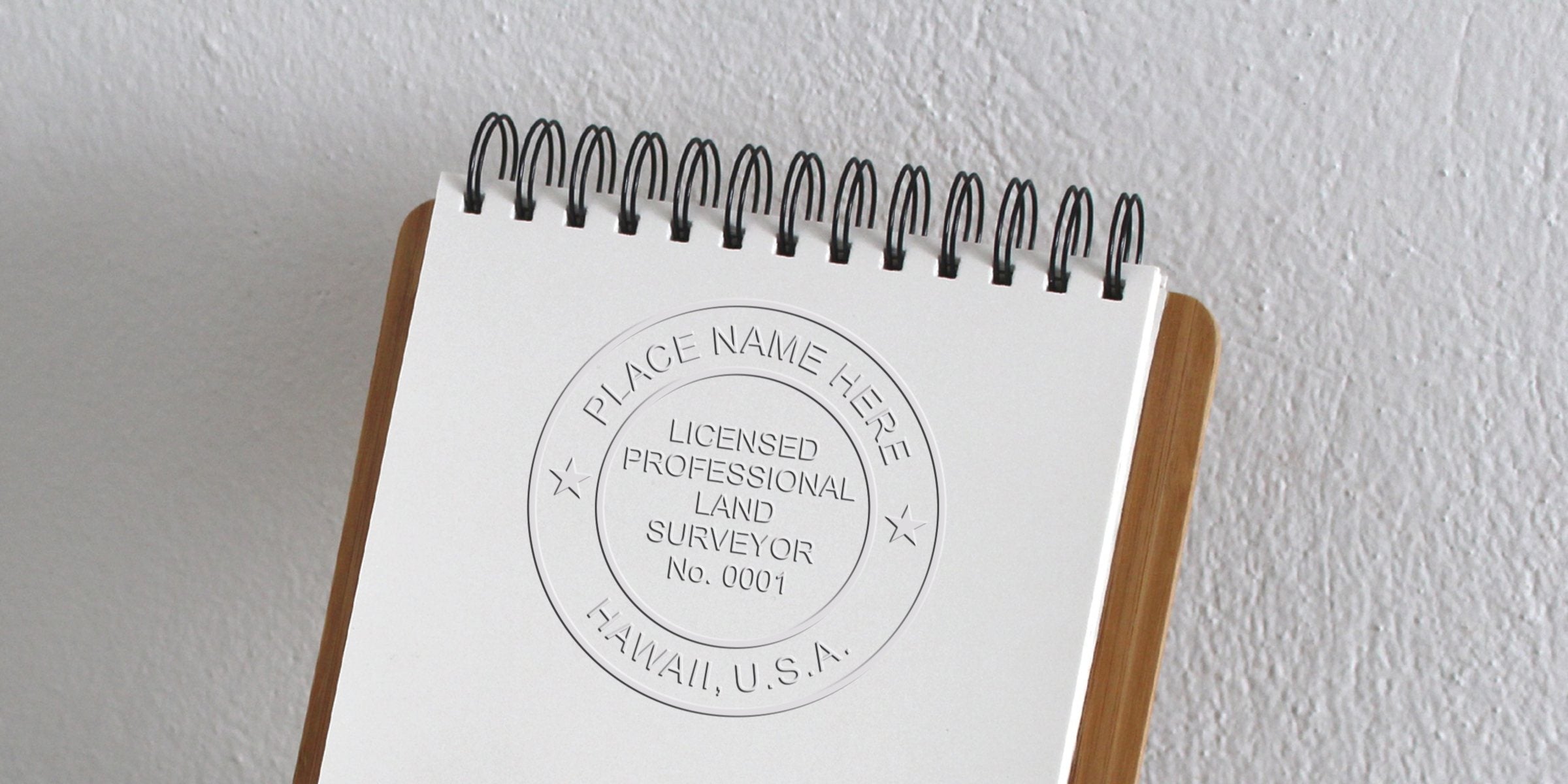 Embossed Hawaii land surveyor stamp on white notepad with wooden clipboard, adhering to professional land surveyor guidelines.