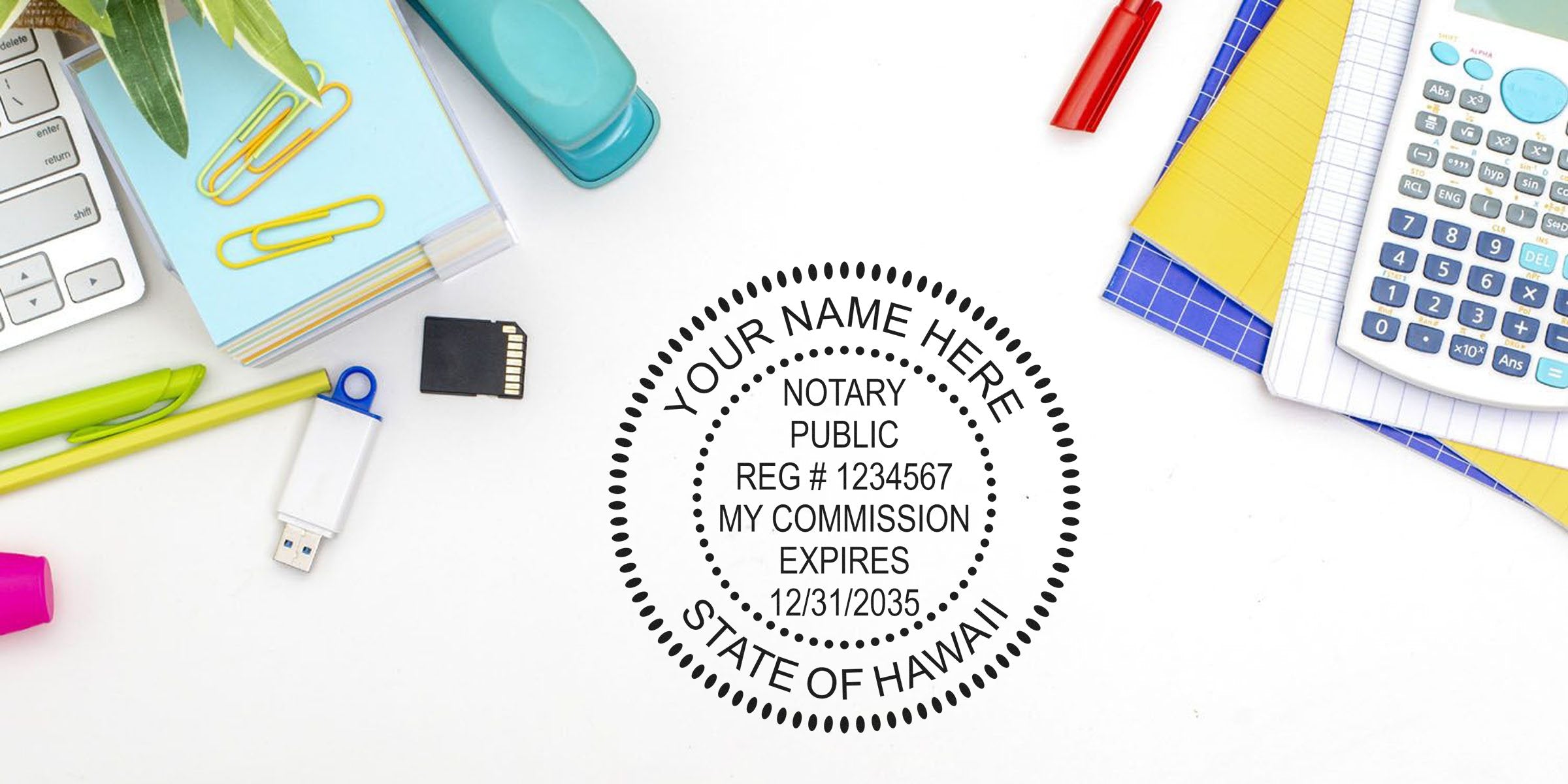 Self-inking notary stamp with commission expiration date on desk, next to calculator, USB drive, and stationery, representing Hawaii notary supplies.
