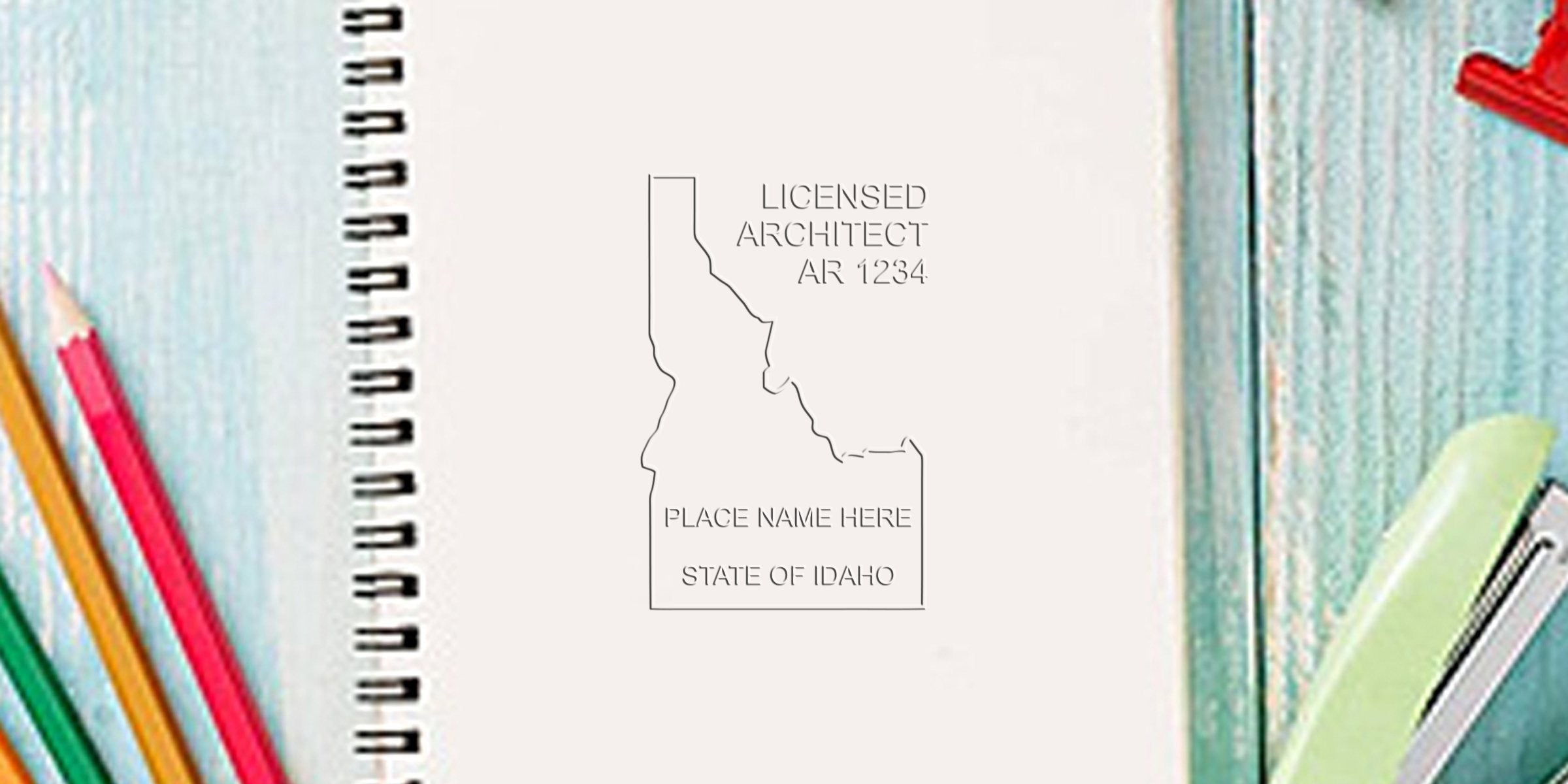 Idaho architect stamp on notebook with colored pencils and stapler, showcasing architectural design tools and options for Idaho licensed architect stamps and online purchases.