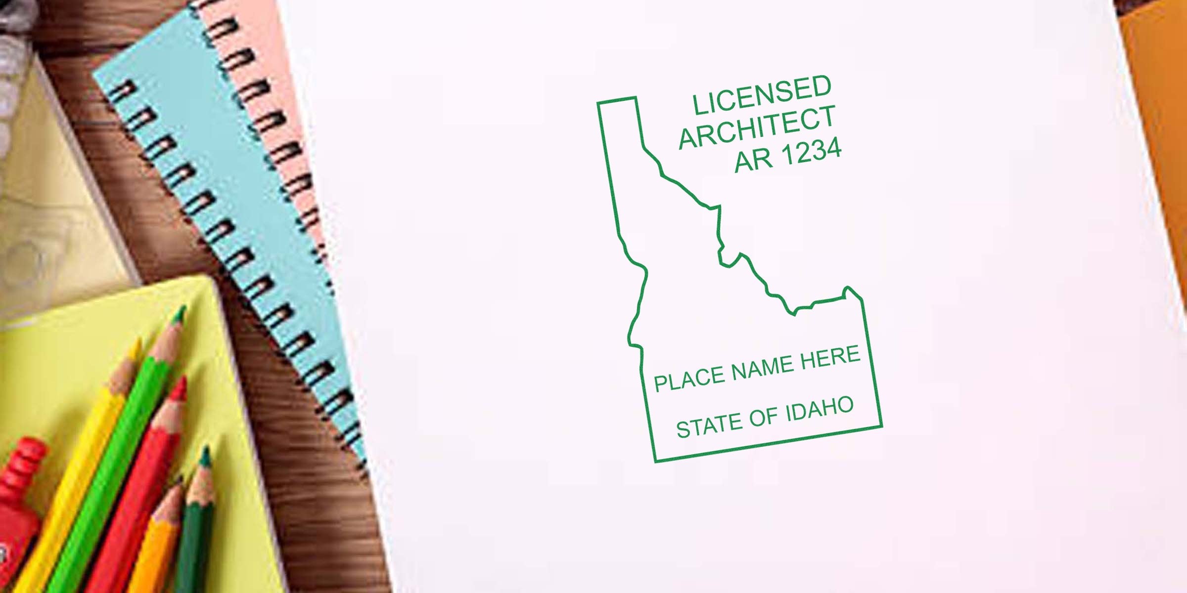 Idaho architect stamp on white paper with colored pencils and notebooks on wooden desk, showing stamp size and meeting Idaho architect stamp requirements.