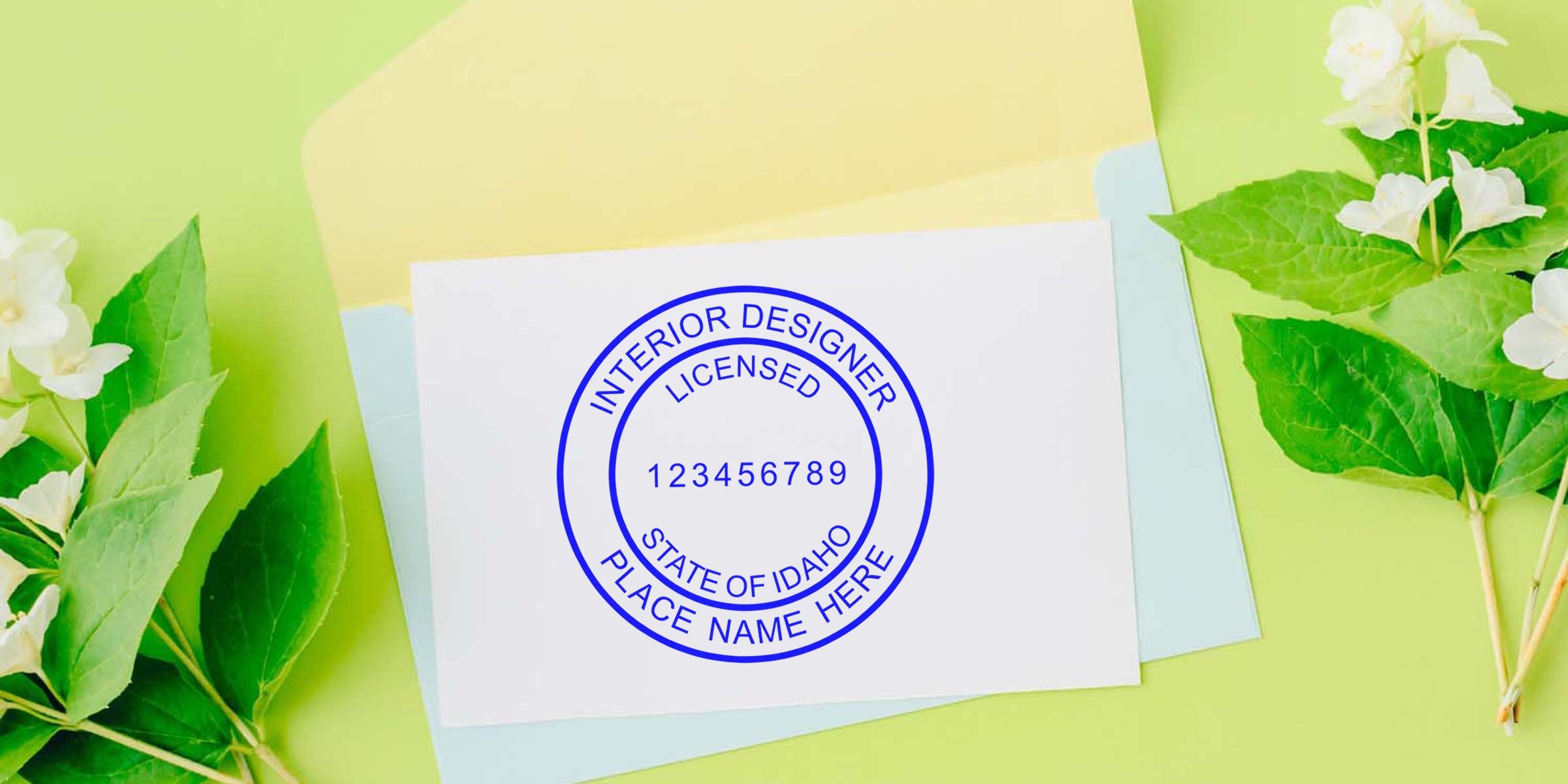 Licensed interior designer stamp on white paper with green leaves and pastel envelopes, showing Idaho interior designer certification seal and highlighting Idaho interior design regulations and licensing.