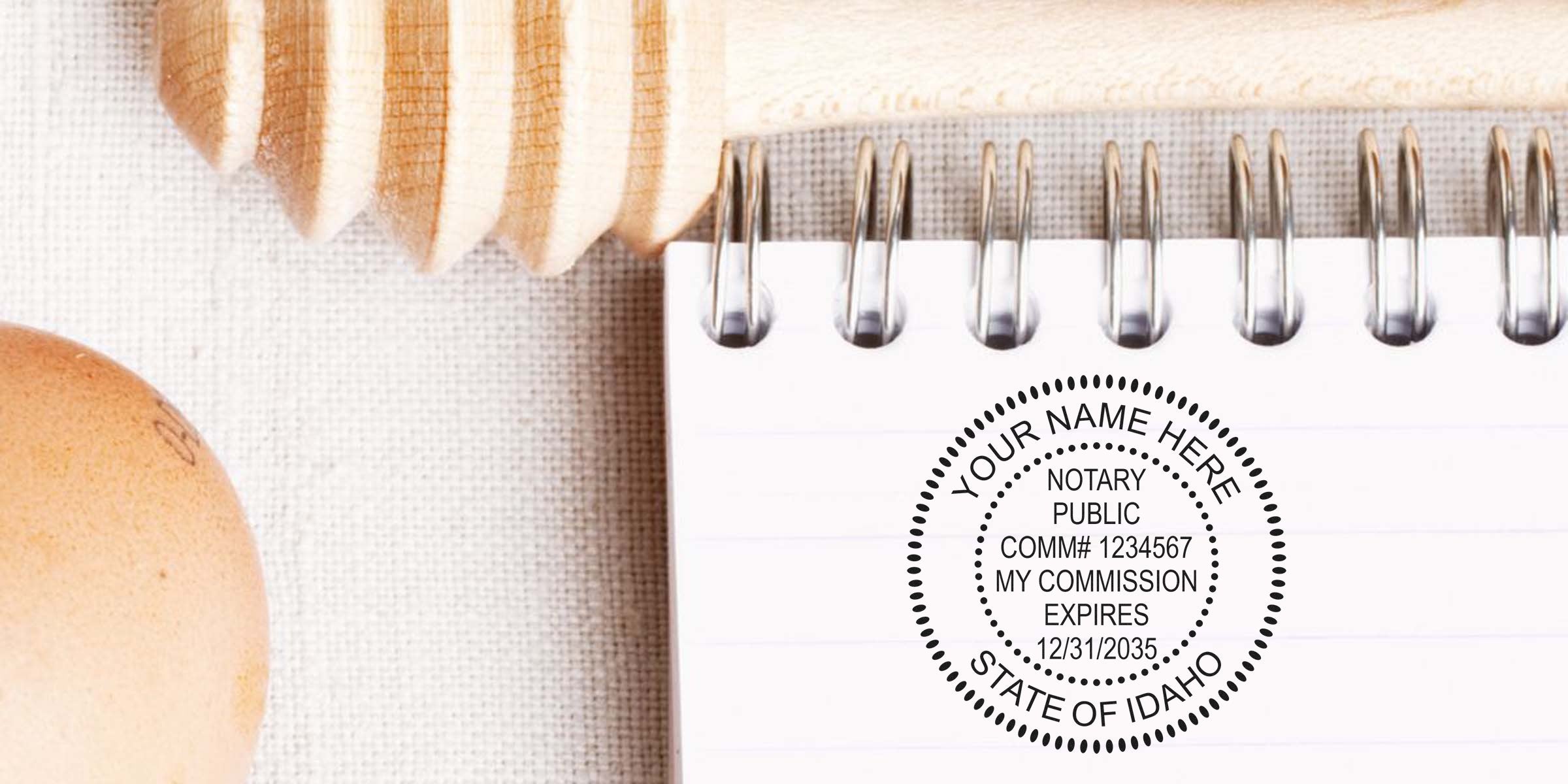 Idaho notary stamp on a spiral notebook showing commission expiration, a key notary public supply.