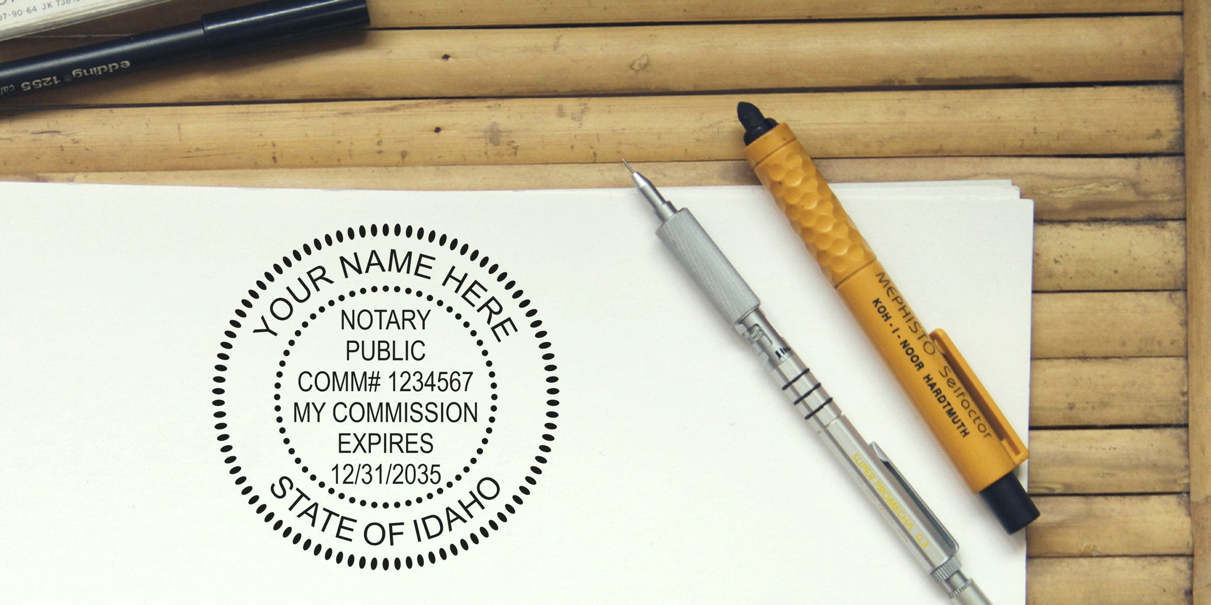 Custom Idaho notary seal stamp with commission details on white paper next to pens, highlighting key notary stamp tips.