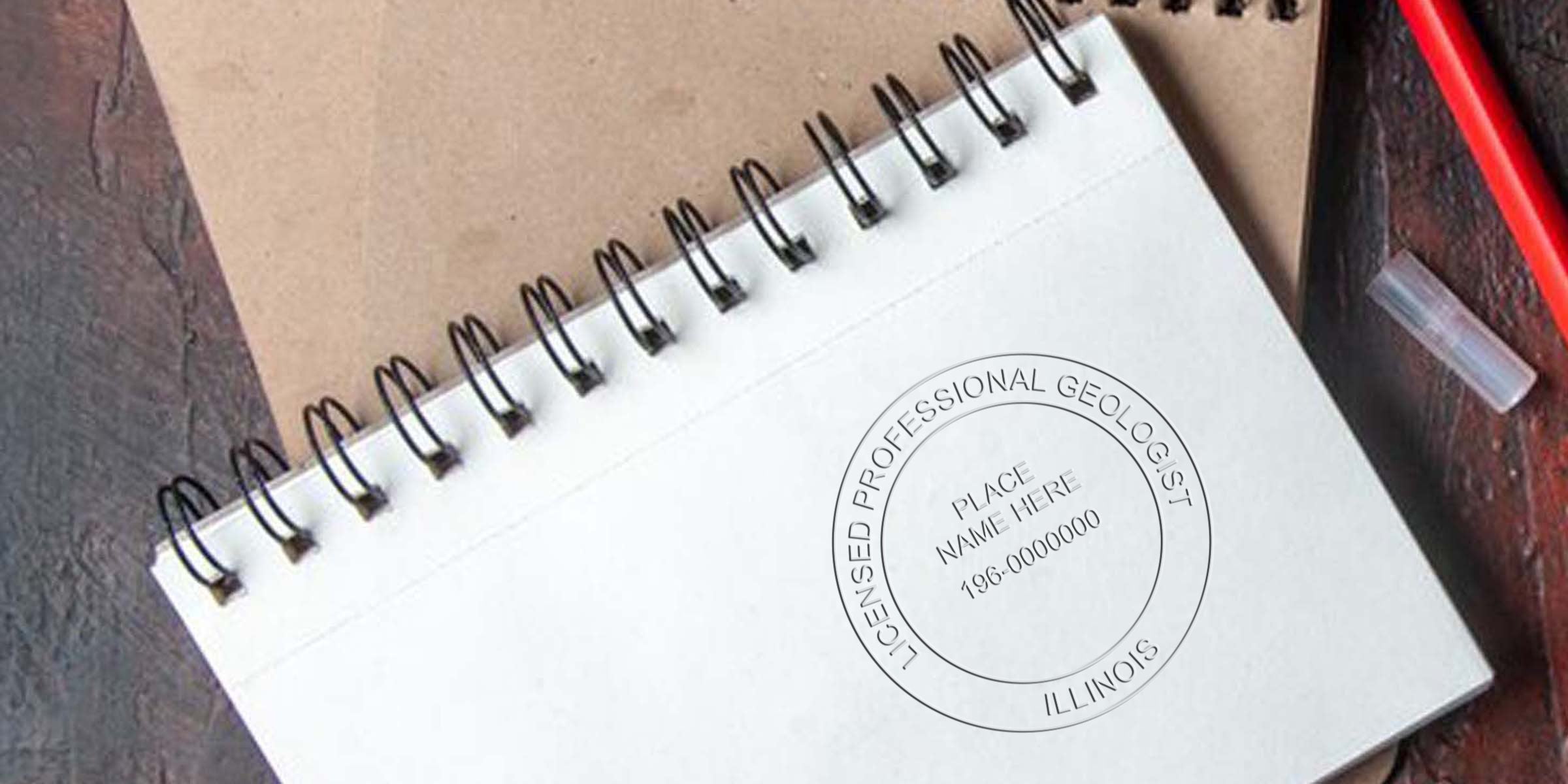 Illinois geologist stamp on spiral notebook with red pen and brown background, showing tips for licensed professional geologist certification.