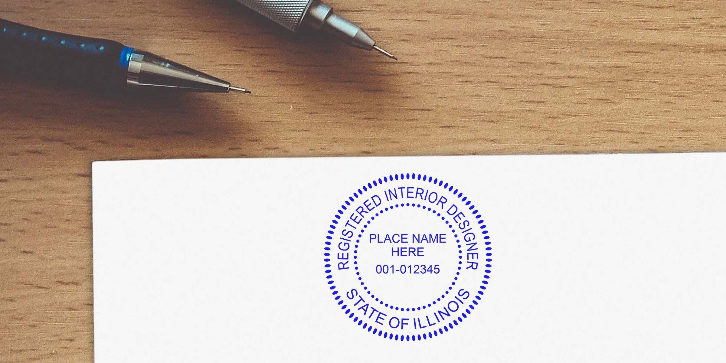 Illinois interior designer's registered stamp on white paper with pens on wooden desk, available for online purchase.