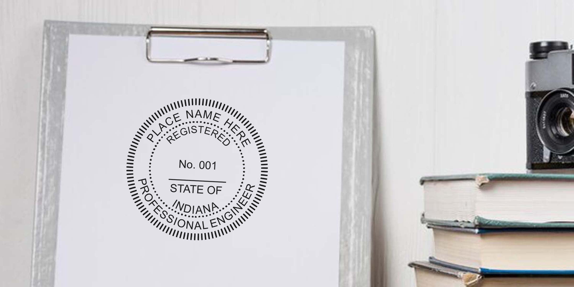 Professional engineer seal on clipboard with vintage camera and books, showing Indiana engineer stamp and official state license mark, emphasizing engineer stamp attachment timing.
